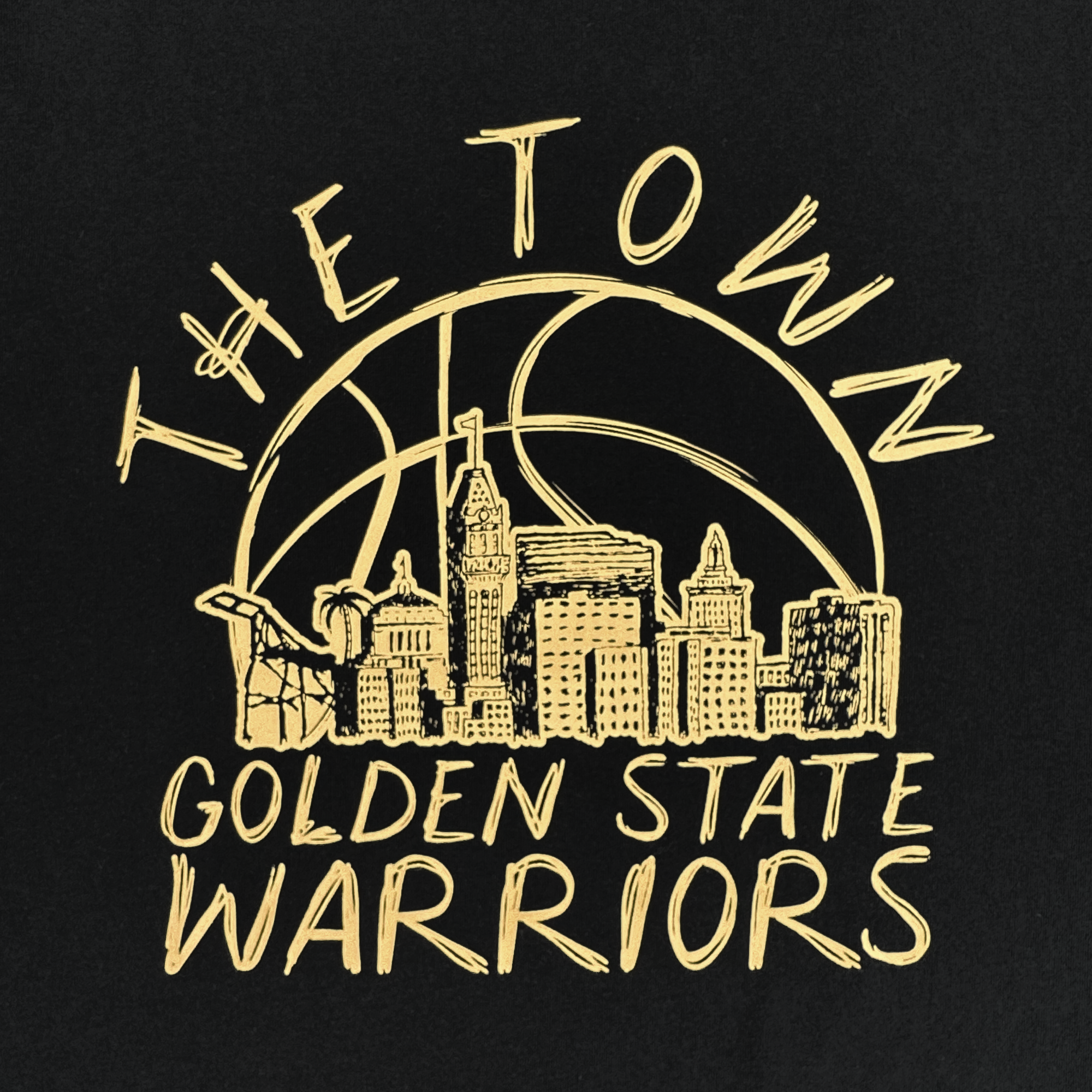 The GSW Town Doodle Tee features a golden line drawing of the Oakland skyline over a basketball, with "THE TOWN" above and "GOLDEN STATE WARRIORS" below, all on sleek black—part of the exclusive Oaklandish Town Collection.