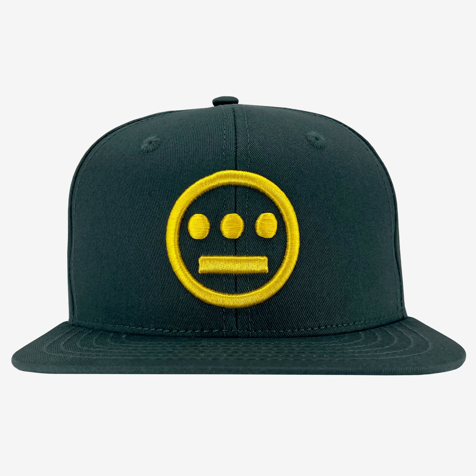 The Hiero Logo Snapback by Hieroglyphics is a dark green flat-brimmed snapback, featuring a prominent yellow embroidered logo on the front. The logo depicts a straight-faced, minimalist face with three dots above it forming a horizontal line, reminiscent of hieroglyphics representing eyes and a mouth. The design stands out against the plain, light-colored background.
