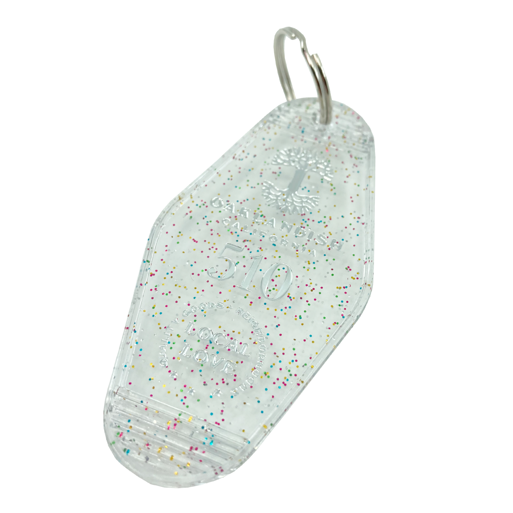 Detailed angle shot of translucent white with rainbow glitter motel-style keychain with Oaklandish Logo and 510 local love.