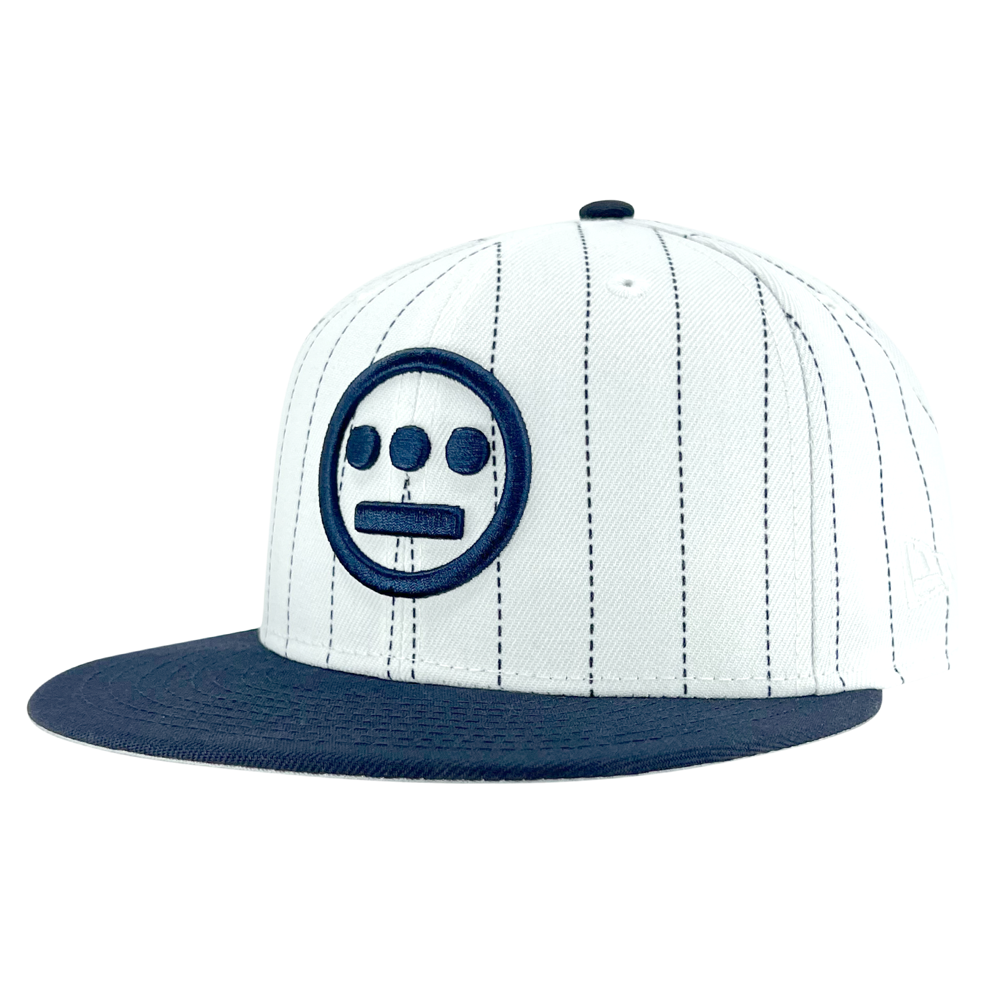 The New Era Hiero Pinstripe 59FIFTY Fitted Cap by Hieroglyphics is a white baseball cap with vertical black pinstripes and a navy blue visor. The front center of the fitted cap prominently features a navy blue embroidered circle with three smaller circles inside and a horizontal line beneath, forming a face-like design reminiscent of hieroglyphics.