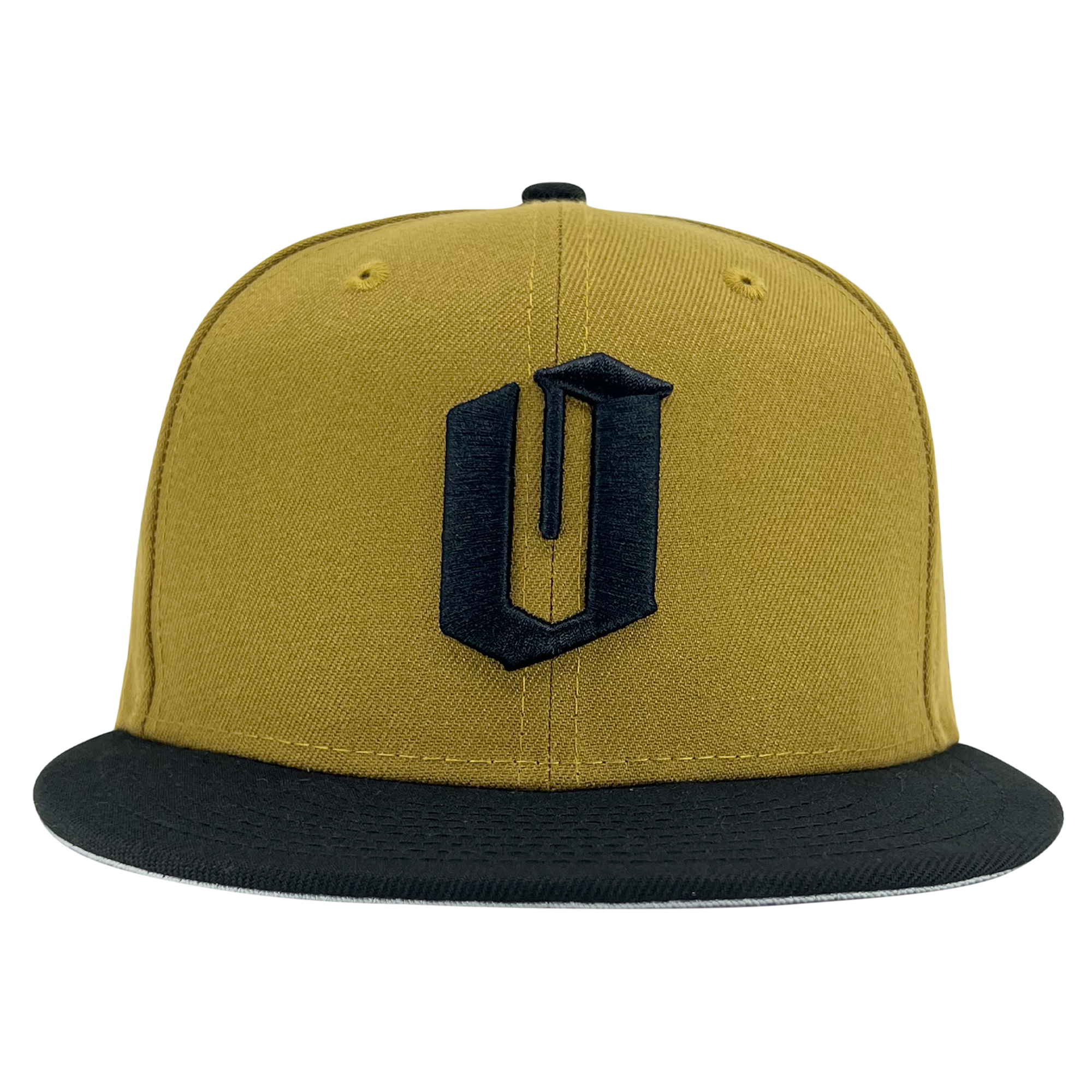 A mustard yellow New Era Official 59FIFTY Fitted Cap by Oaklandish with a black brim. The front of the cap features a bold, black, stylized letter "U" emblazoned on it. This hat has a structured crown and eyelets for ventilation, carrying the distinct Oaklandish vibe.