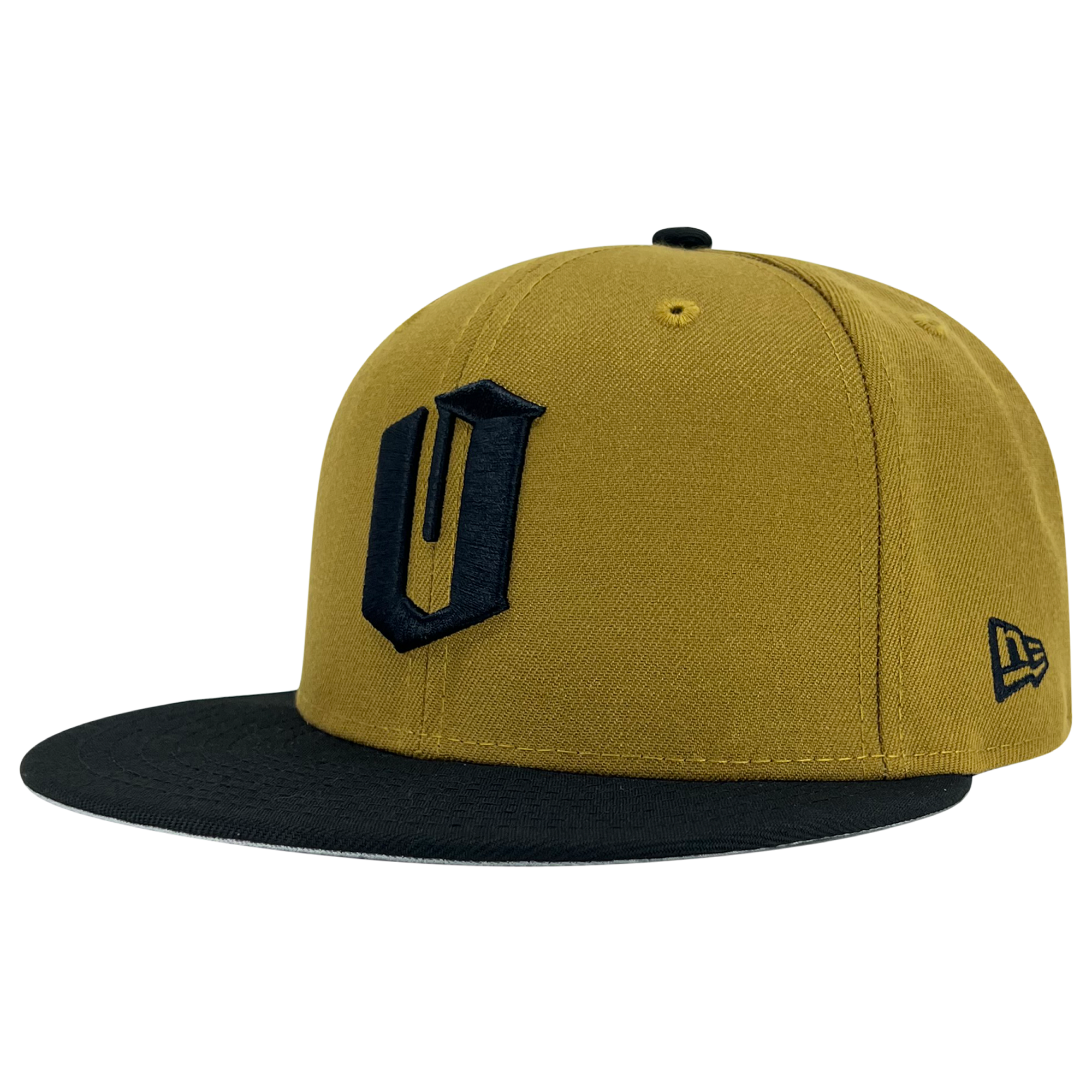 Product Description: The Oaklandish New Era Official 59FIFTY Fitted Cap features a mustard yellow body and a black curved brim. It showcases a large black "U" emblem on the front and the iconic New Era logo embroidered in black on the side. With its structured crown and matching mustard yellow button on top, this cap exudes classic Oaklandish flair.