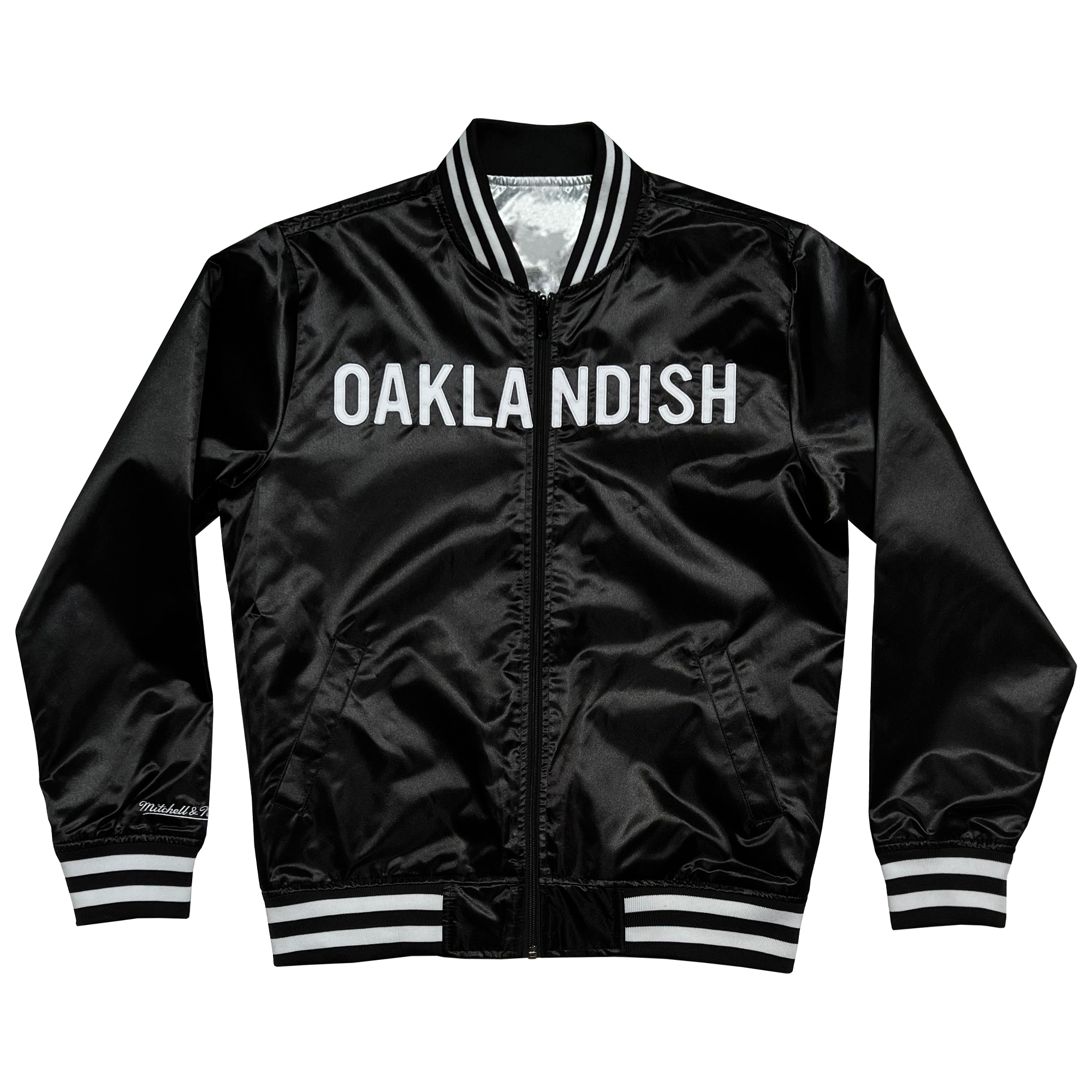 Mitchell & Ness black satin reversible jacket with Oaklandish wordmark across front chest with black and white ribbing at collar, cuff, and waistband.