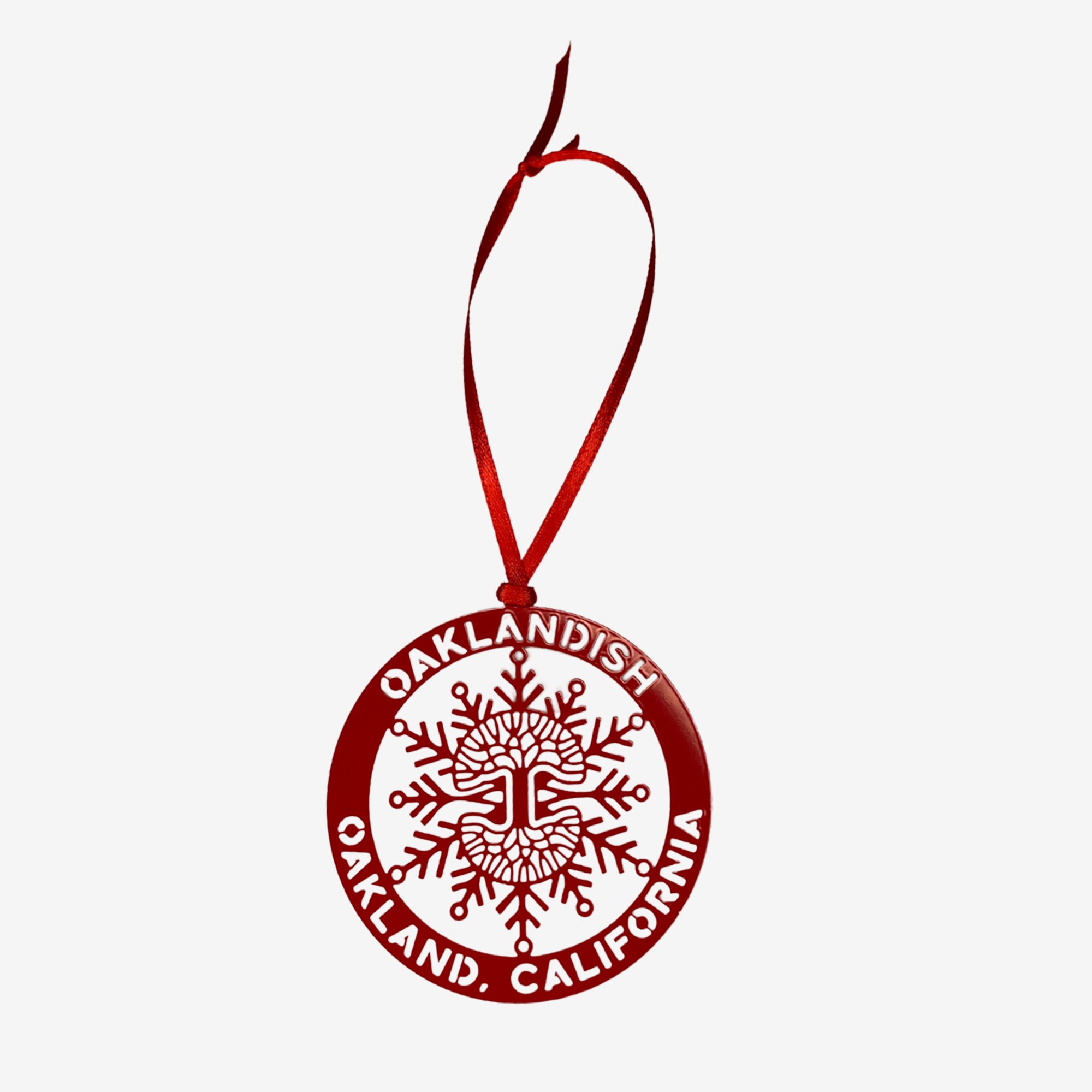 Red Oaklandish holiday tree ornament with Oaklandish wordmark and tree logo in a snowflake.
