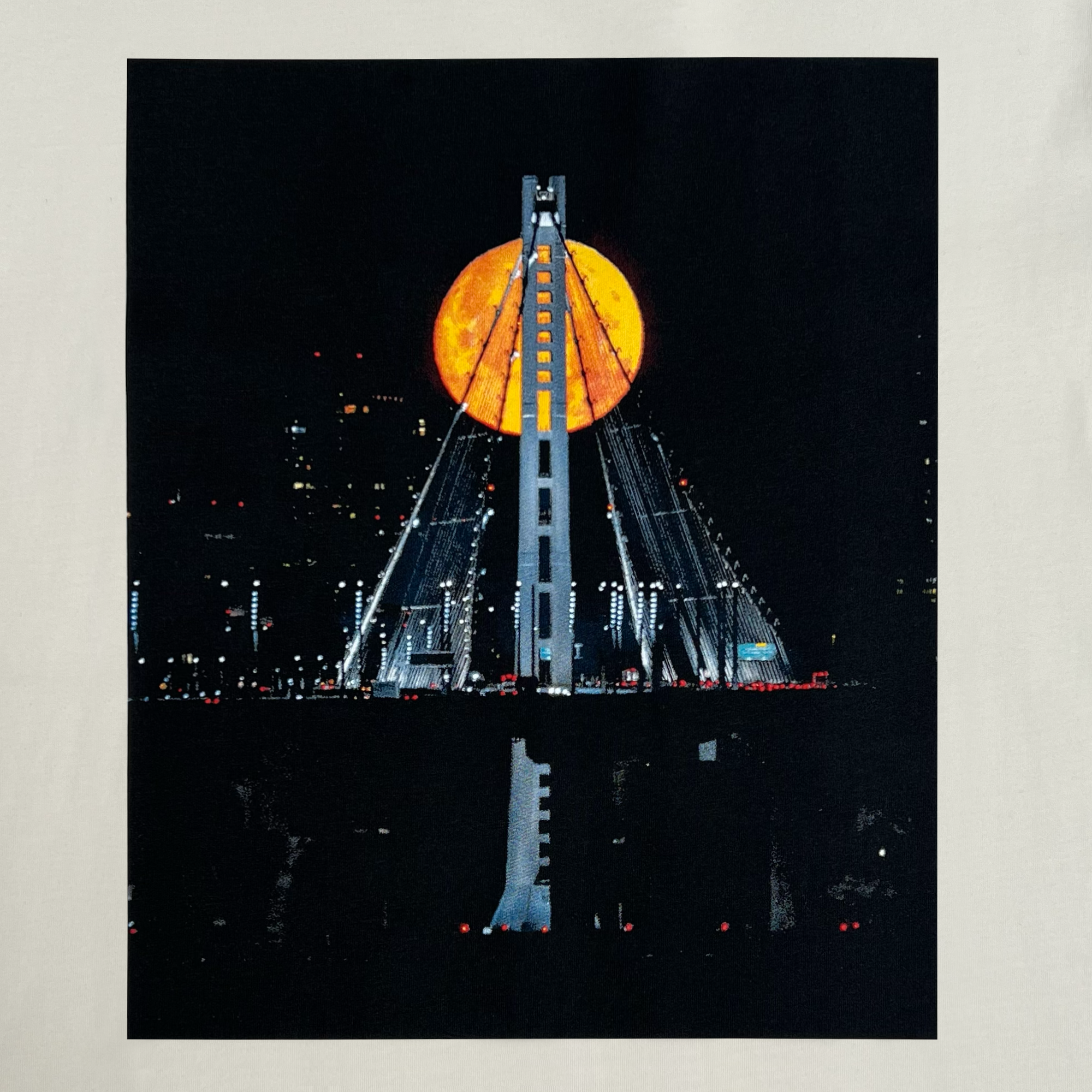 Close-up of the image of Strawberry Moon over the Oakland bridge by landscape photographer Vincent James on a natural cotton t-shirt.