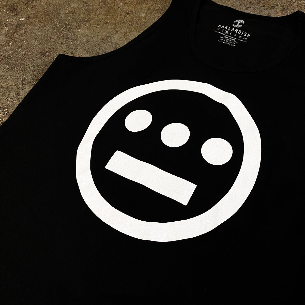 Black tank top with white Hieroglyphics hip hop logo on the chest on asphalt.