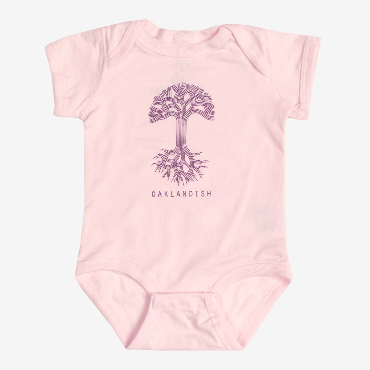 Pink infant one-piece with a purple Oaklandish tree logo and wordmark on the chest.