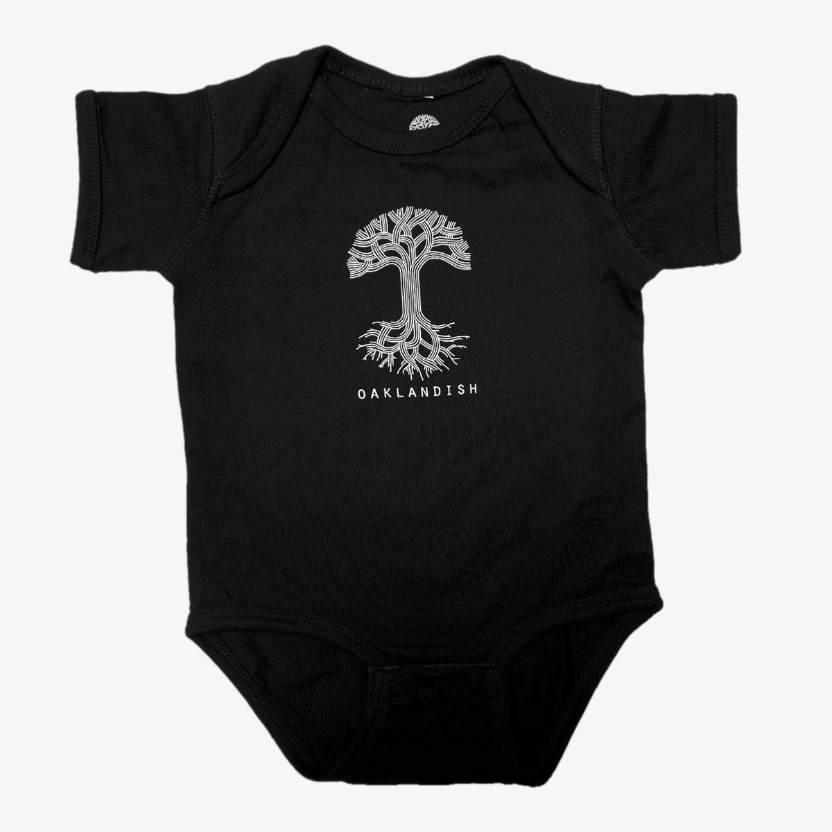 The Infant Oaklandish Classic Logo One-Piece by Oaklandish is a black baby romper showcasing a stylized silver tree with spreading roots and branches at its center. Below the tree, "OAKLANDISH" is written in capital letters. Made from 100% cotton, this onesie features a round neckline, short sleeves, and a reinforced snap closure for easy changes.