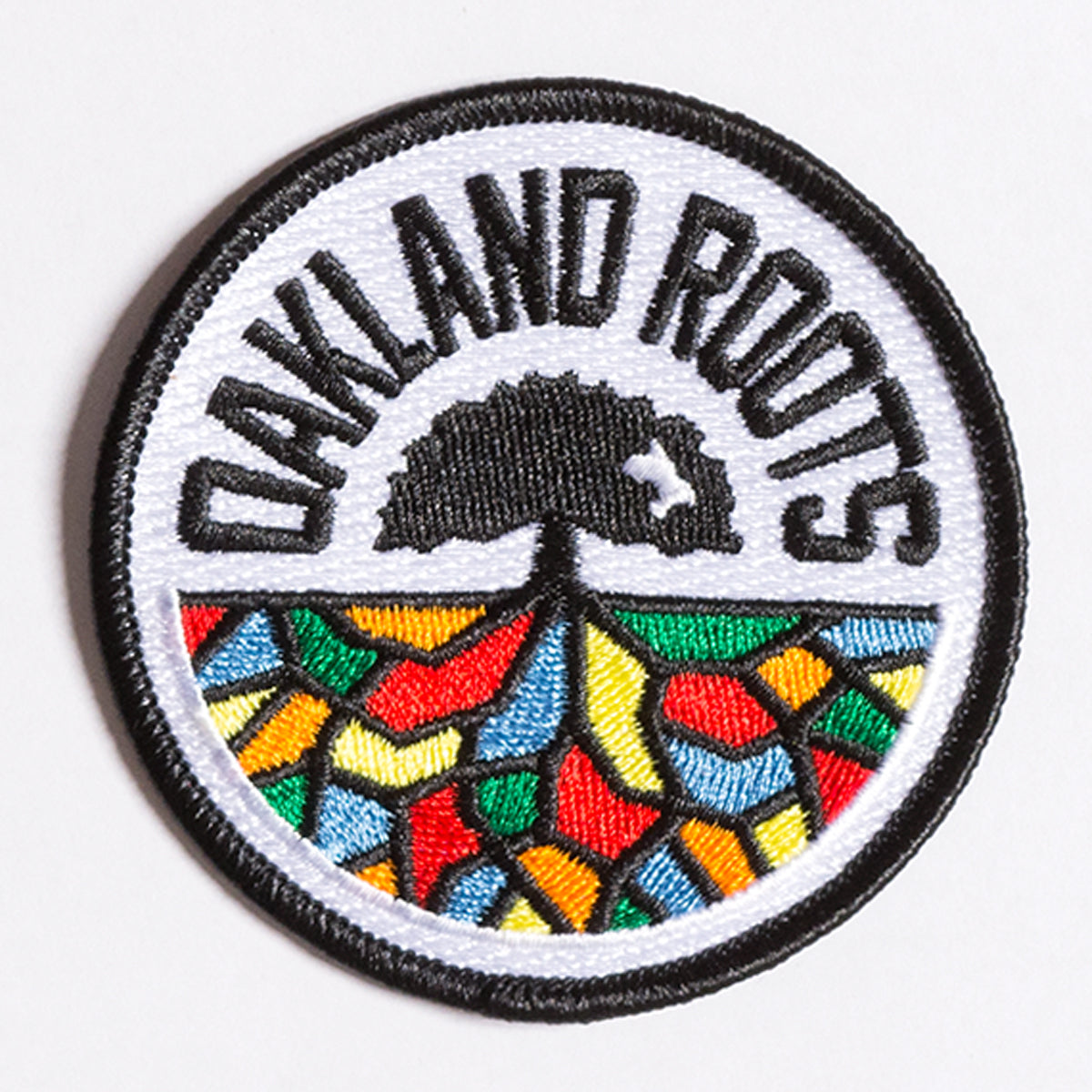 Embroidered round patch of Oakland Roots full-color logo crest.