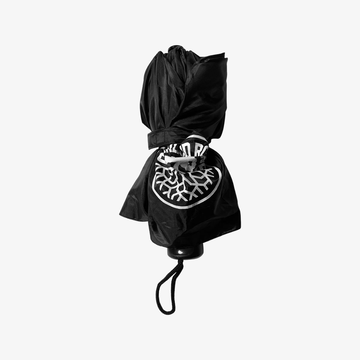 A black umbrella collapsed to show it is small enough to store in a tote bag. 