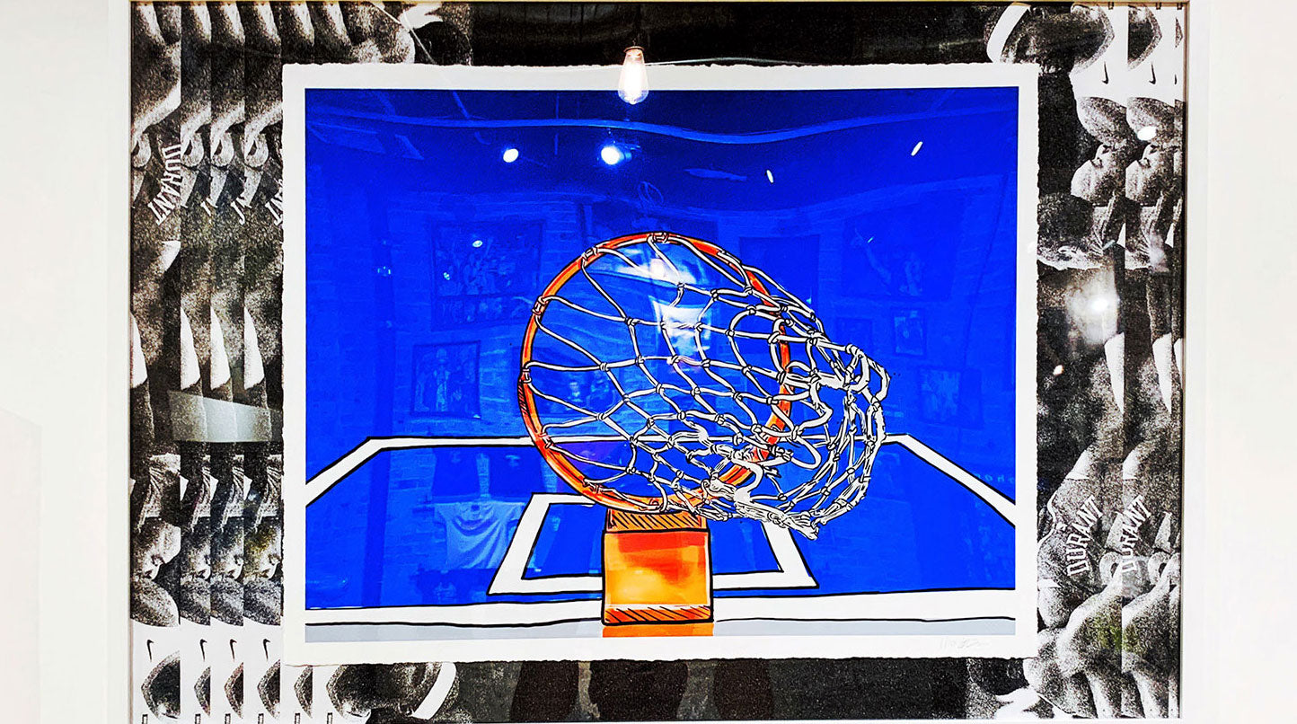 Artwork with a black and white frame, in the center a rectangle of blue with a view of a basketball net from below, hand illustration style.