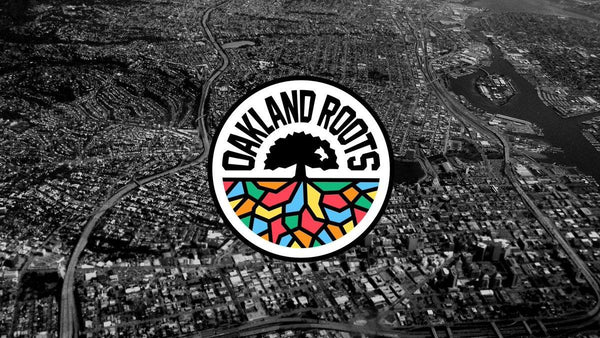 Oakland Roots SC crest against a black and white aerial view of Oakland.