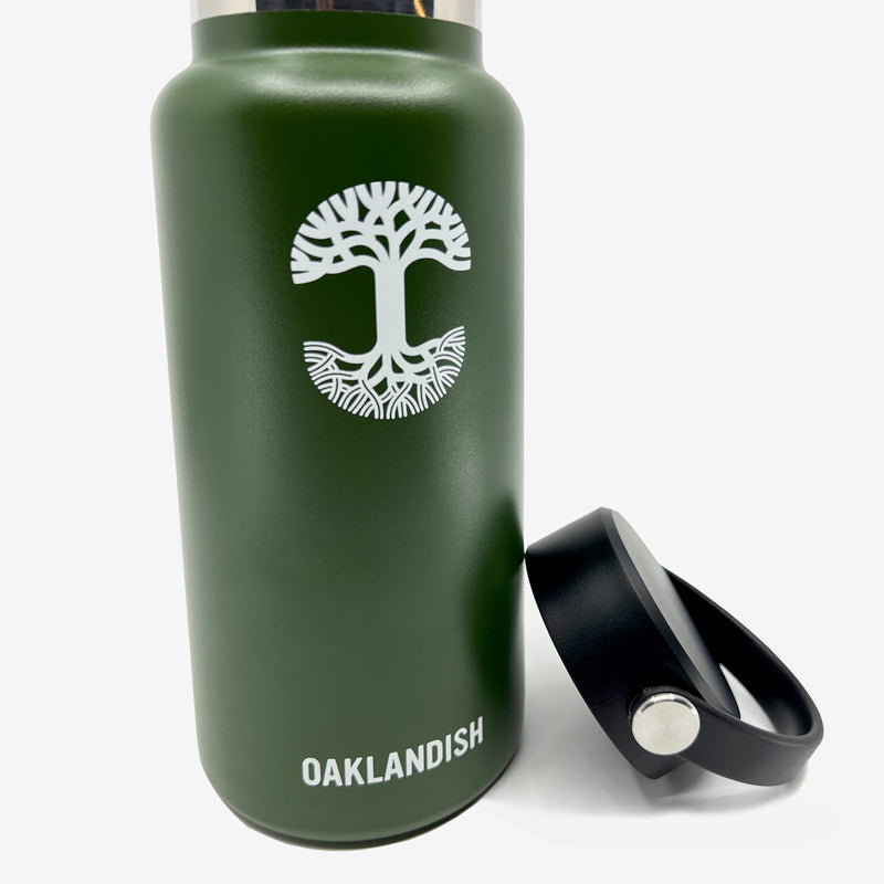 Close-up of green stainless steel 32 oz water canteen with white Oaklandish wordmark, logo, and black screw top lid.