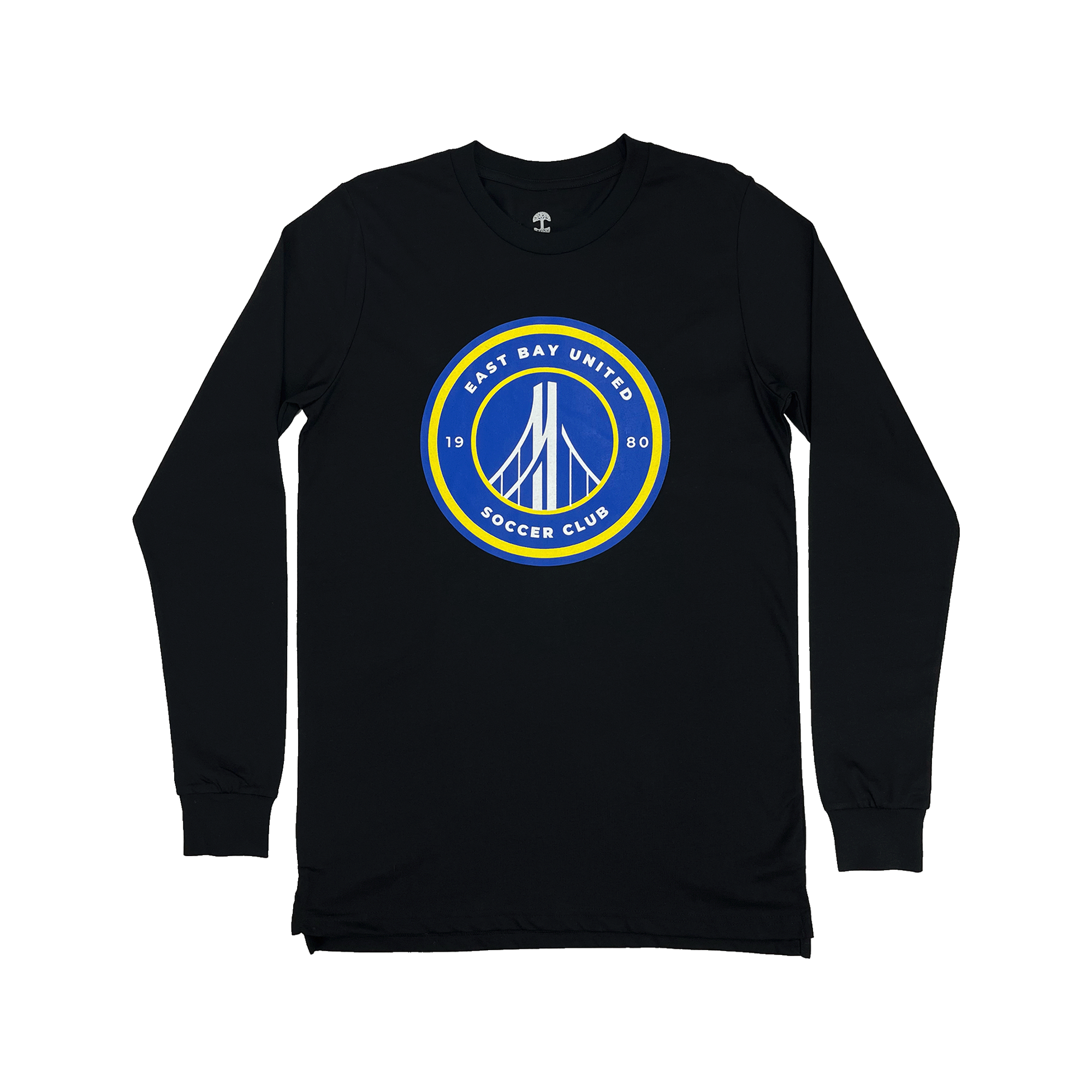 The EBU Long Sleeve Tee by Supported Brands is a black shirt with long sleeves, featuring a circular emblem prominently displayed on the front center. The emblem showcases a blue background with a white bridge illustration at its core, encircled by a yellow border. Surrounding the bridge design, the text "East Bay United Soccer Club" and "1980" are finely written in white letters, celebrating the storied youth soccer club.
