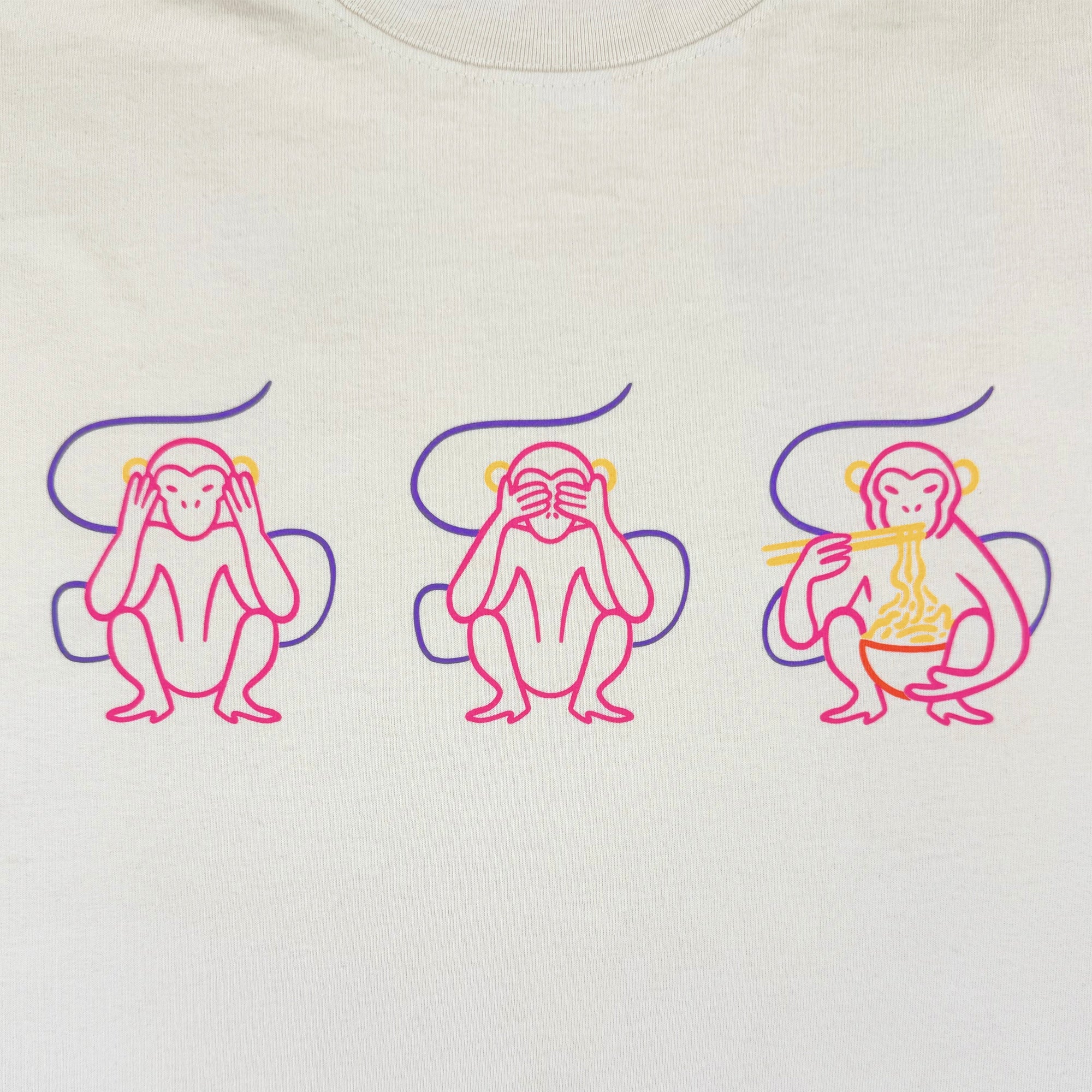 The Jo's Modern Thai X Oaklandish Tee by Oaklandish features three stylized monkeys on white—one covering eyes, one ears, and one eating noodles with chopsticks—each highlighted by playful purple swirls.
