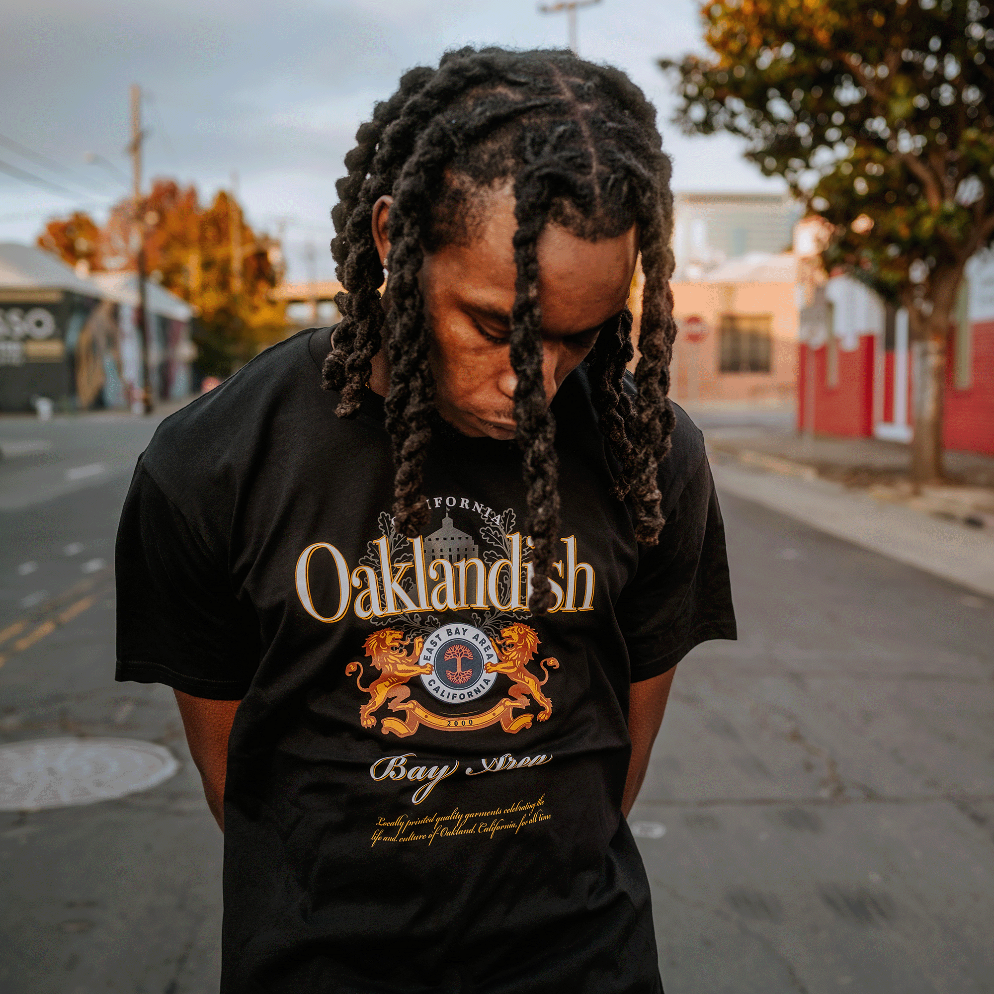 Model wearing a black t-shirt with Lager Negra logo made over with a Bay Area, Oaklandish, California styling.