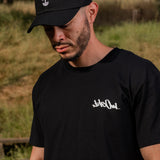 Front view of man wearing black label 510 black t-shirt with design by artist Nite Owl.