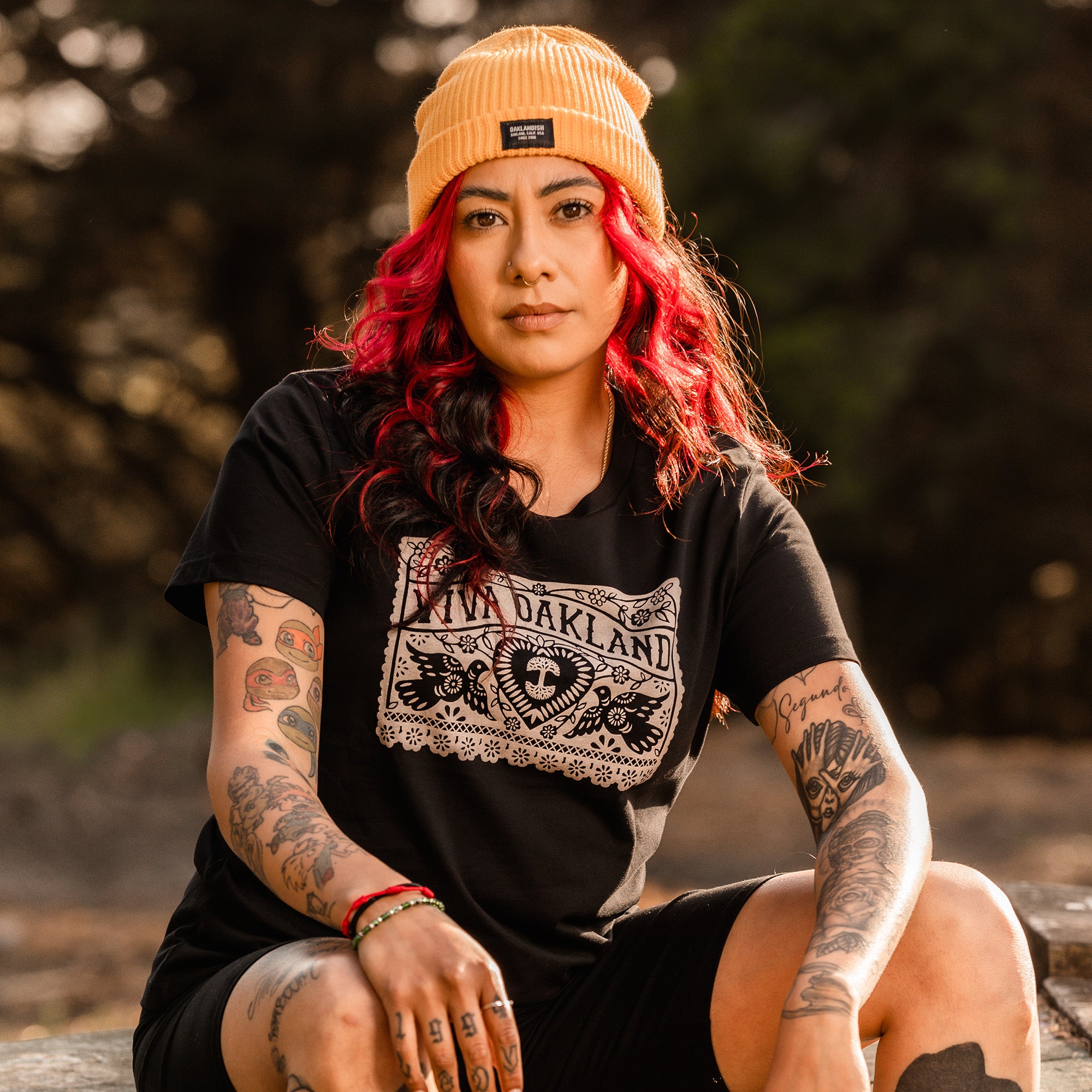 Woman wearing Viva Oakland Black t-shirt outdoors