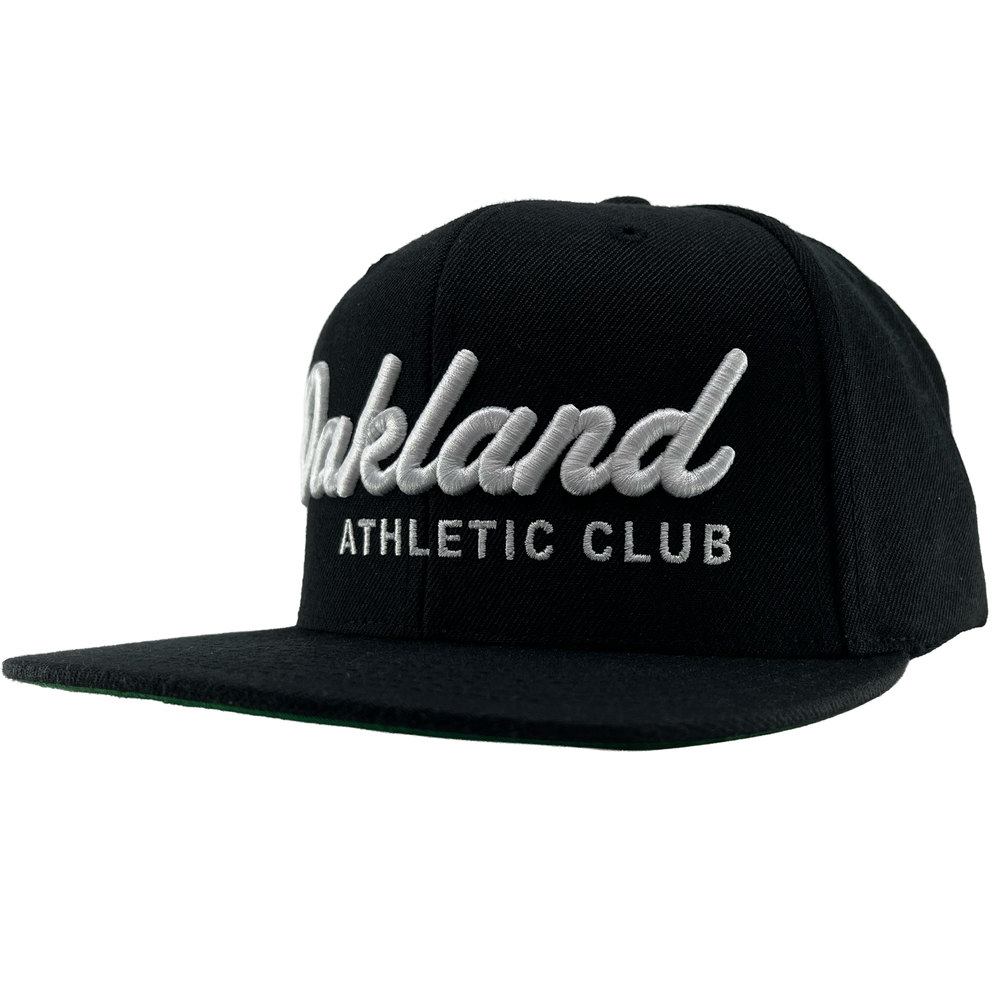 The OAC Script Snapback by OAC is a black snapback cap featuring white embroidered “Oakland” in cursive with “ATHLETIC CLUB” in bold capital letters beneath it. This adjustable hat is displayed at a slight angle on a plain white background, highlighting the classic style of the Oakland Athletic Club.