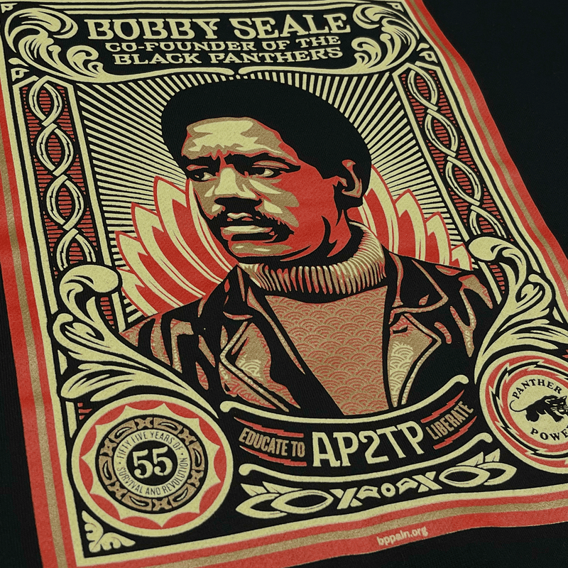 Detailed close-up of the large illustrated graphic by Shepard Fairey, founder of Black Panthers, on a black limited edition hoodie. 