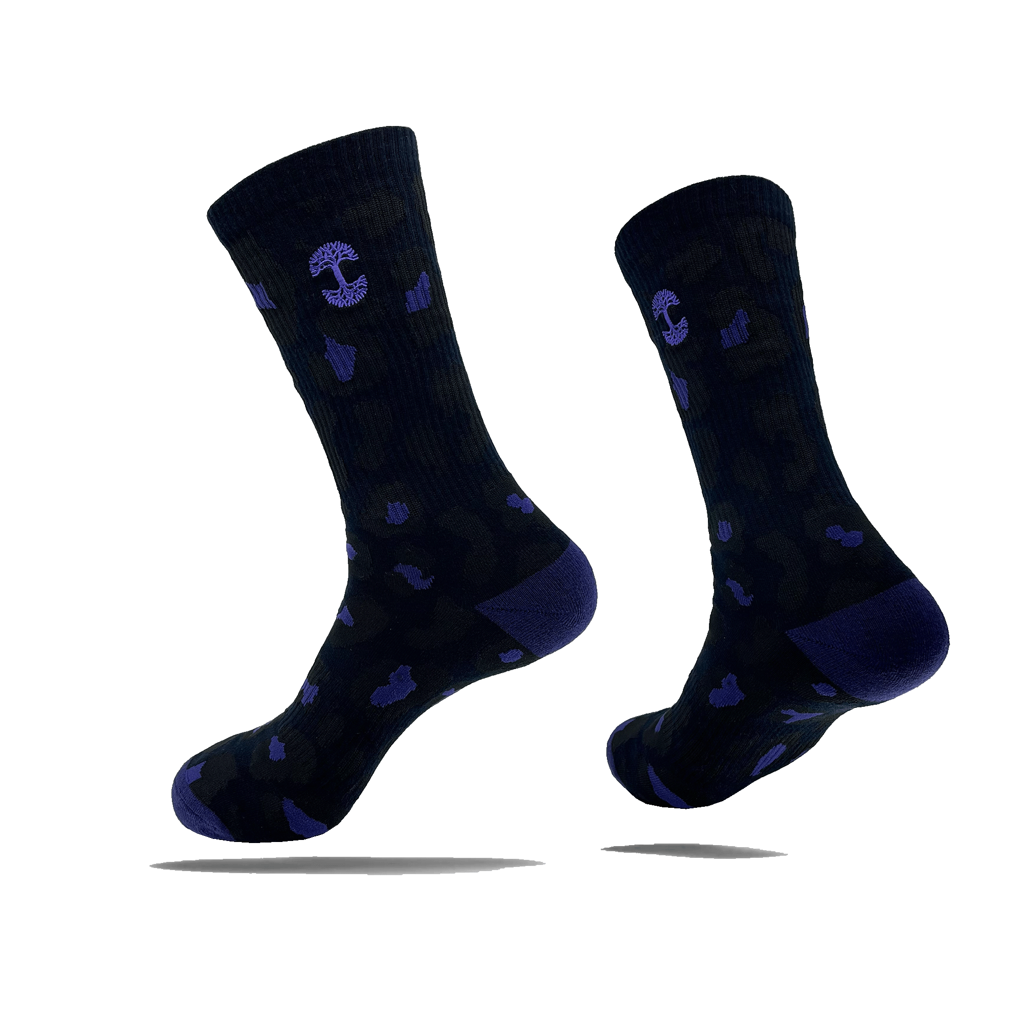 Introducing the Oaklandish Panther Sock: a versatile pair of black crew socks adorned with a subtle camouflage pattern, featuring small purple accents and anchor symbols. These mid-calf length socks come with dark heel and toe sections, creating an illusion of floating in mid-air when displayed against a light background. Designed as one size fits most for versatile wear.