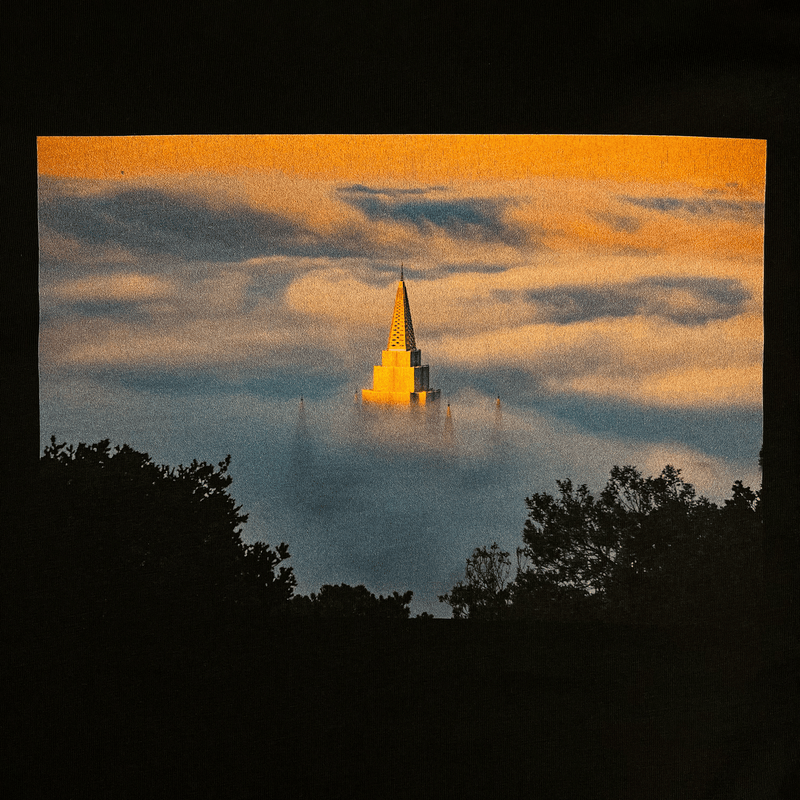 Close-up of black t-shirt with an image of Temple surrounded by fog by landscape photographer Vincent James.