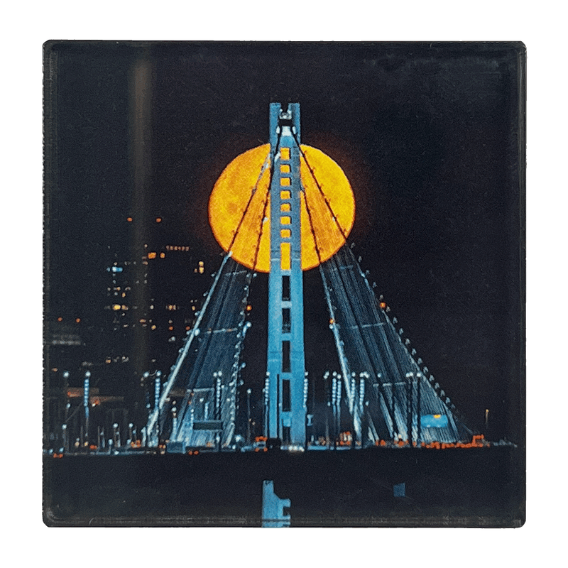 Image of full moon over Oakland's Bay Bridge by photographer Vincent James.