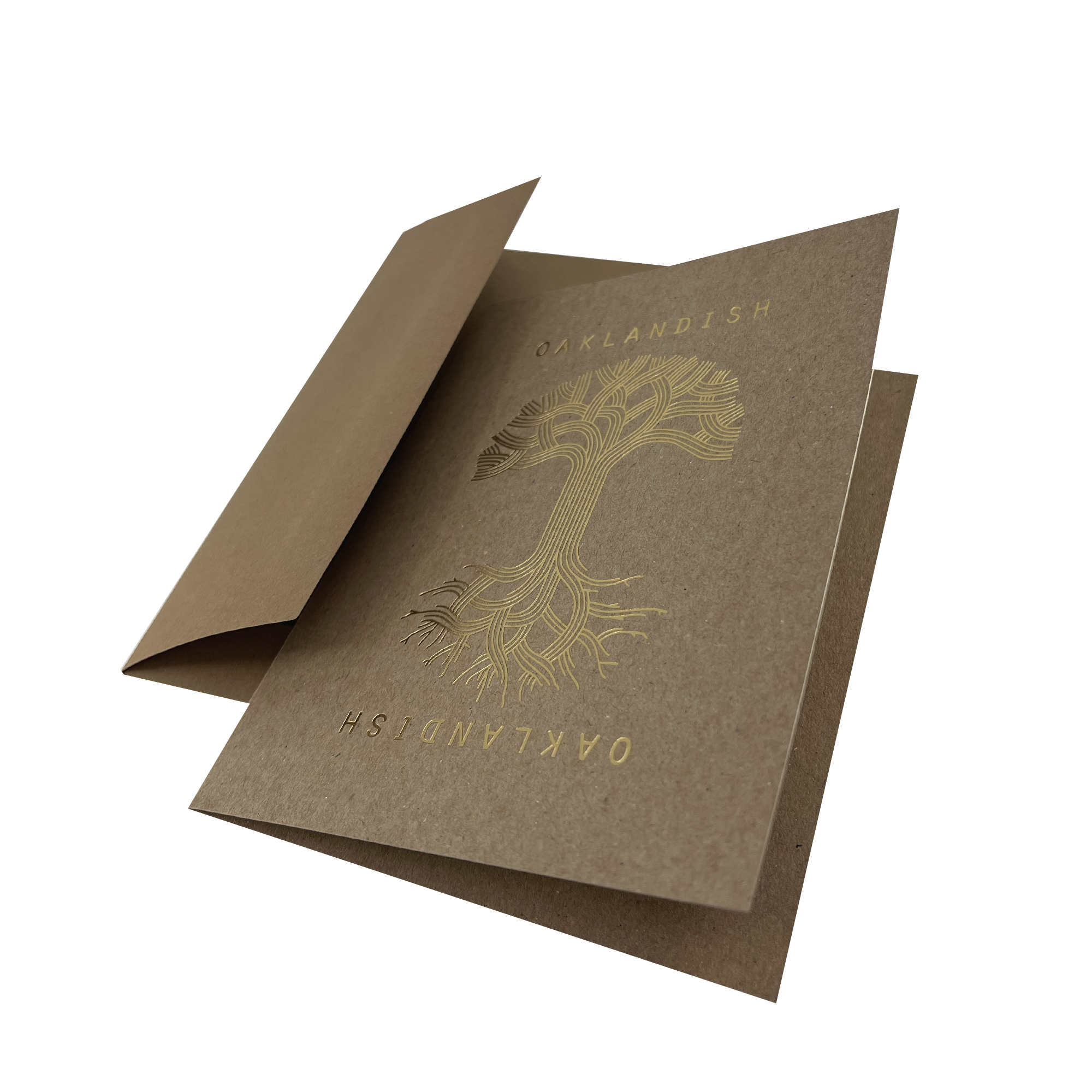Introducing the Oaklandish Classic Logo Card by Never Elsewhere: This elegant brown greeting card features "Oaklandish" in metallic gold foil along both the left and right sides. The centerpiece highlights a stunning letterpress gold foil design of a tree with expansive roots and branches. The card is partially open, revealing its blank interior, perfect for your personal message.