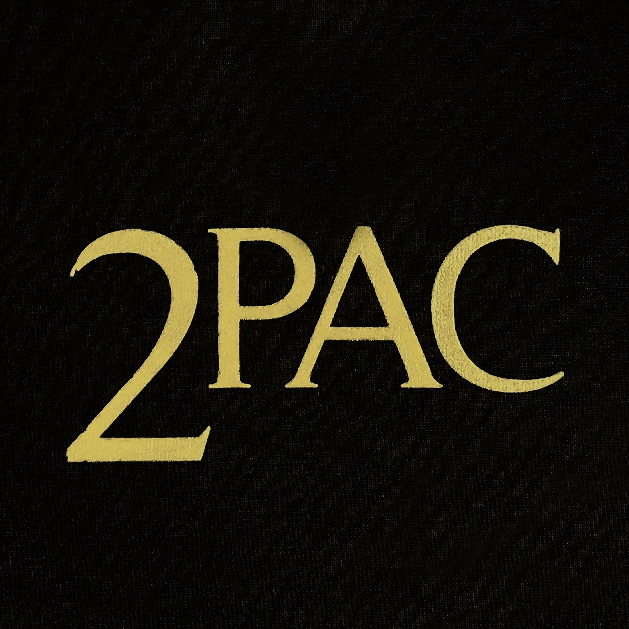 The image displays a black background featuring the text "2PAC" in large, bold, gold letters. This design pays tribute to Tupac's legendary hip-hop legacy by perfectly aligning the "2" with "PAC." Reflecting Oaklandish style, this imagery is both centered and iconic.