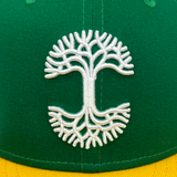 Detail close-up of white embroidery of Oaklandish tree logo.
