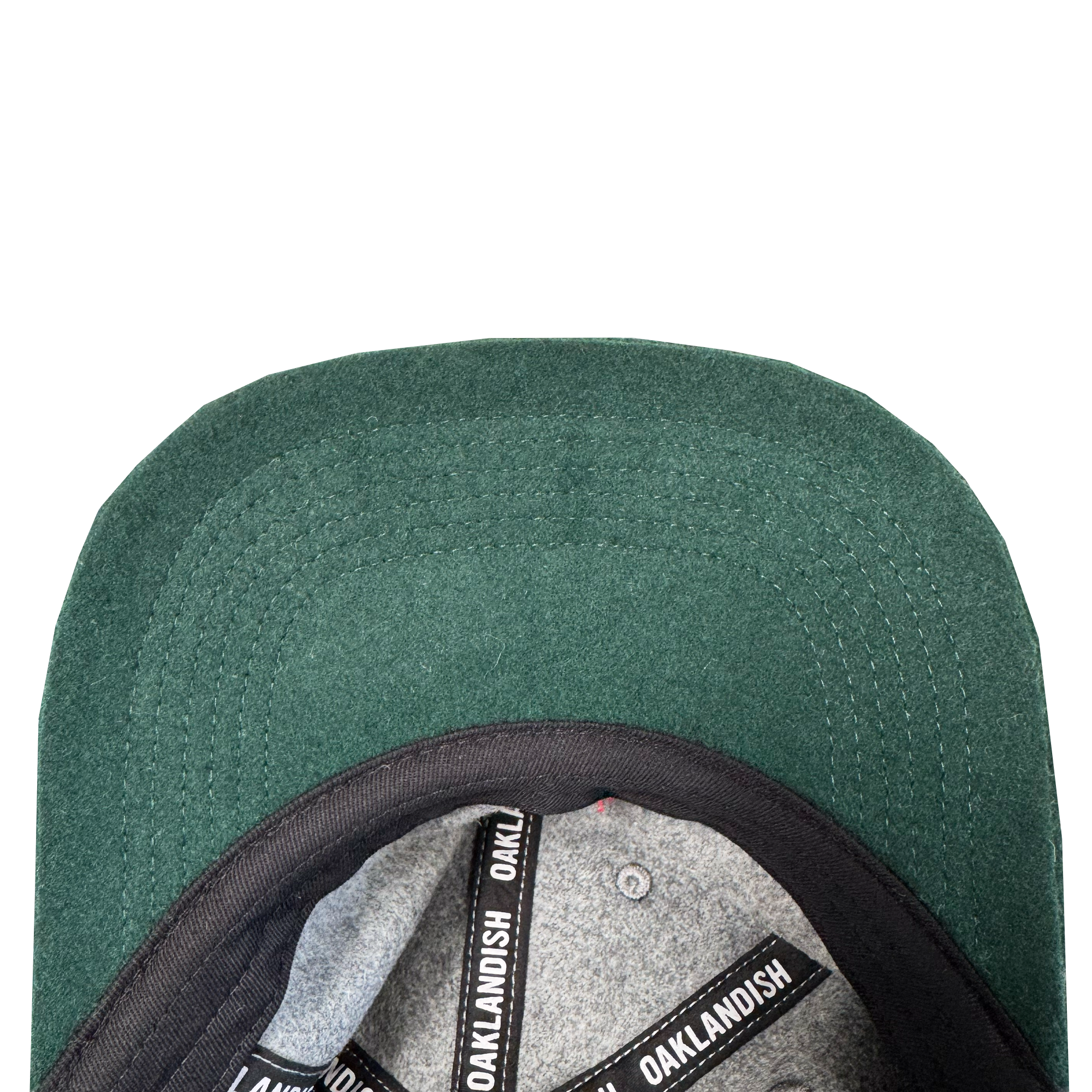Close-up of the Oakland Ballers B Strapback by Oakland Ballers, featuring a green suede-like brim, black inner band, gray lining with black “OAKLANDISH” text strips, and crafted from a polyester wool blend.