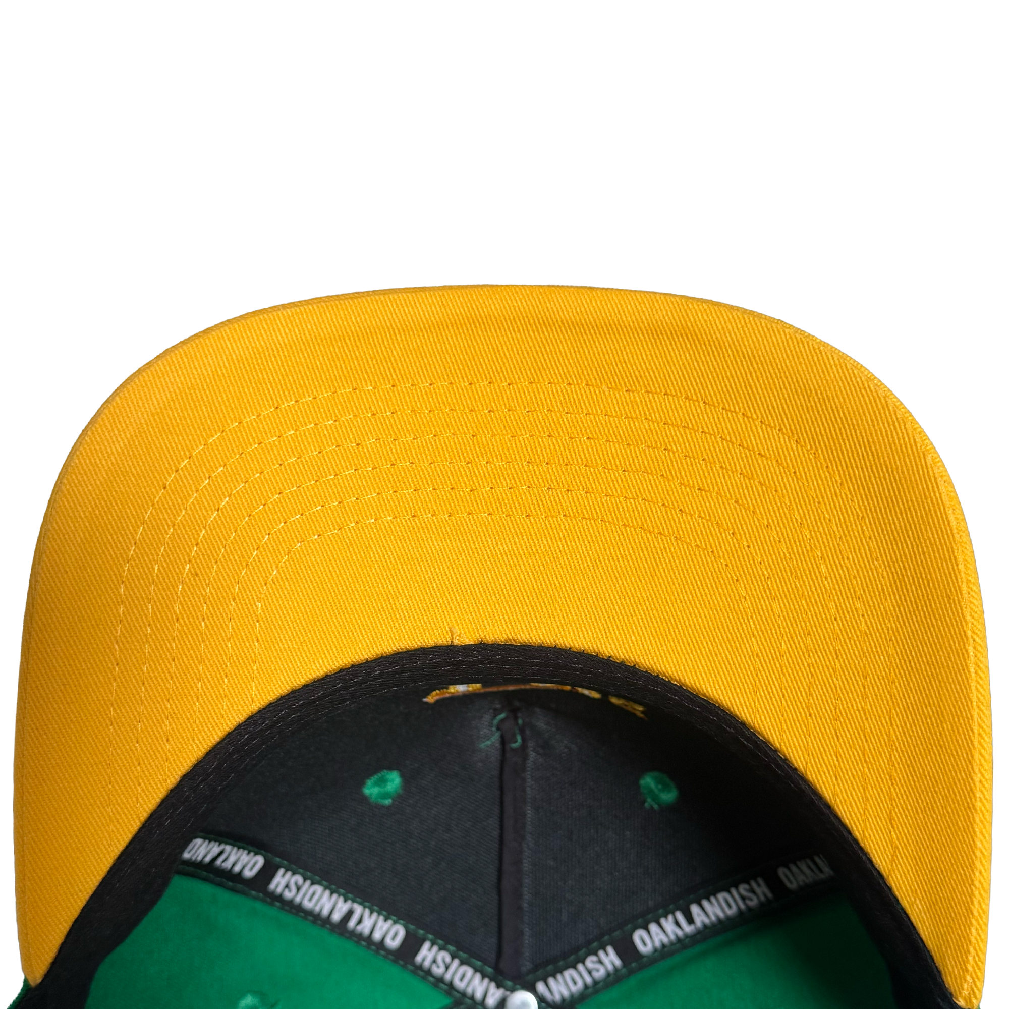 A top-down close-up of the Oakland Ballers 5 Panel Cap by Oakland Ballers, featuring a bright yellow bill, black and green interior with “OAKLANDISH” printed on the lining, all set against a plain white background.