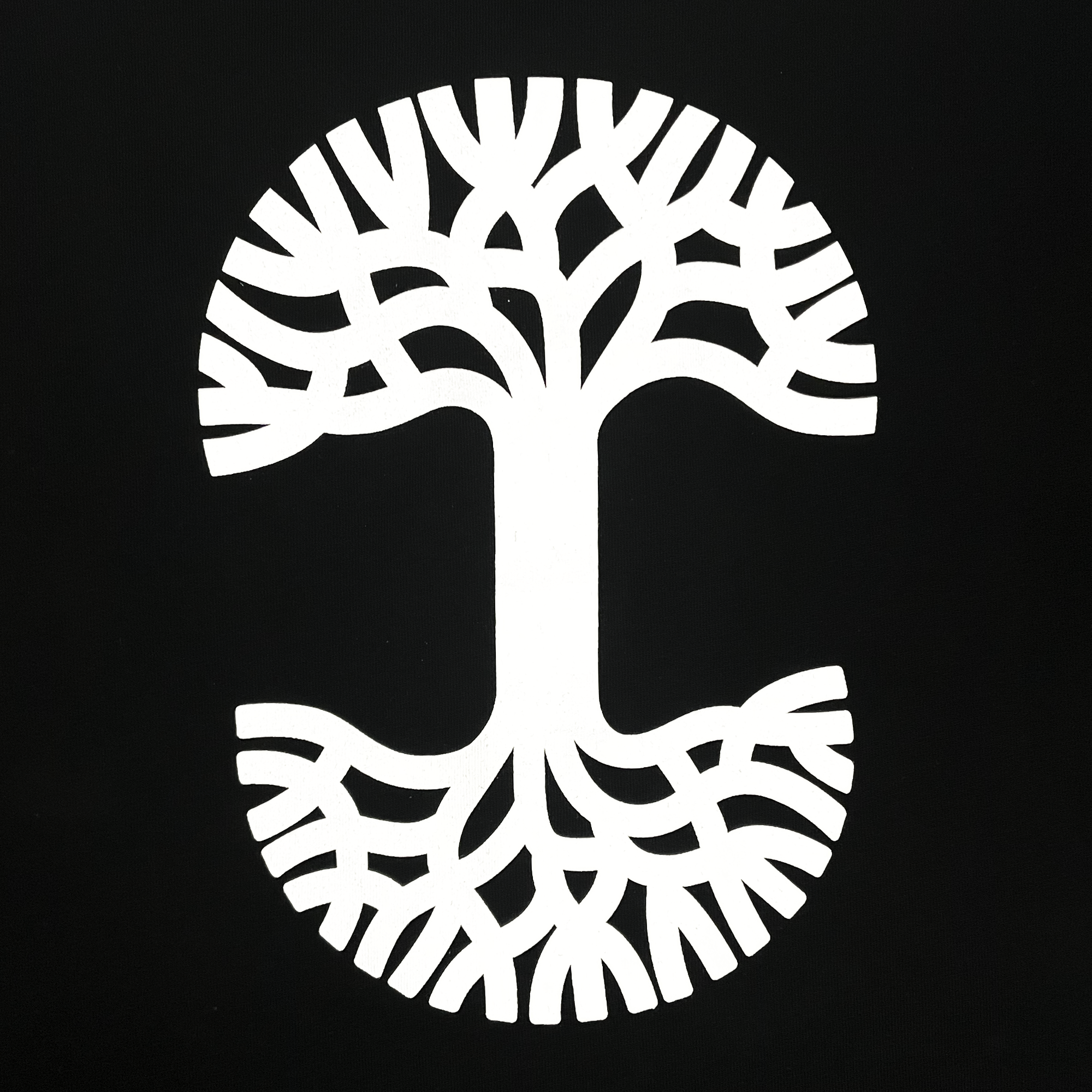 Detailed close-up of large white Oaklandish tree logo on the back of a black button-up baseball jersey.