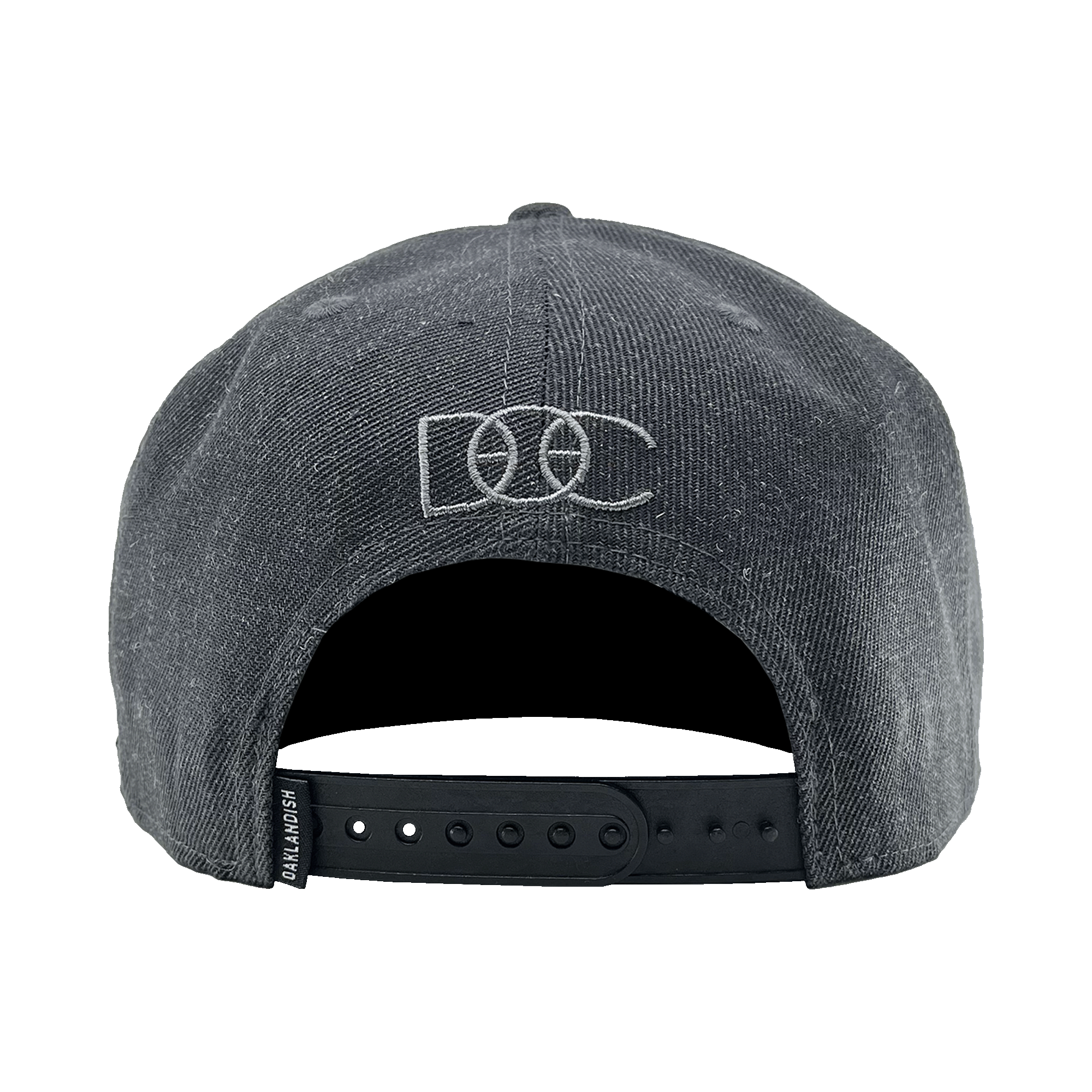 The back view of a charcoal hat with a snapback closure, a small OAKLANDISH tag, and a grey embroidered overlapping DOC wordmark.