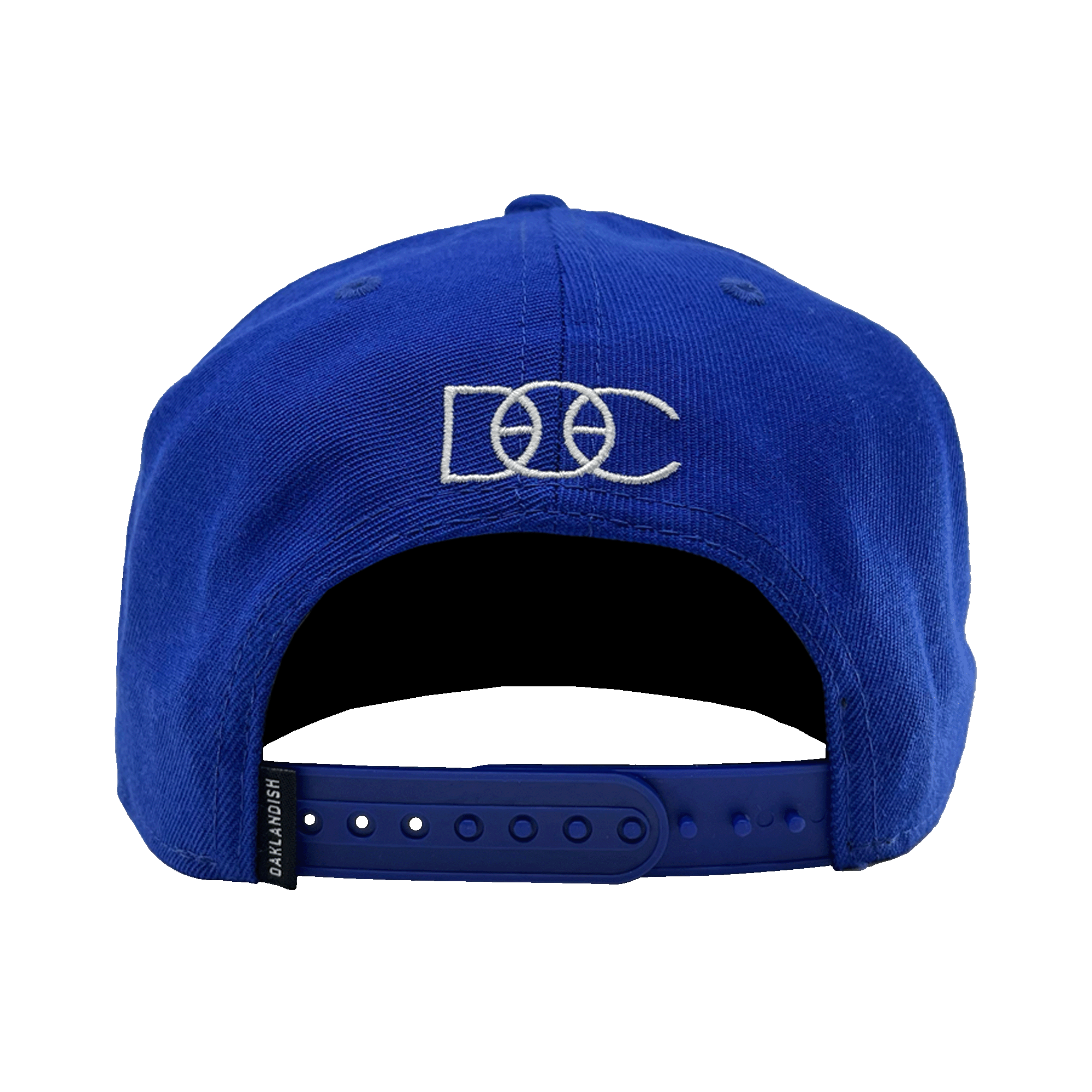 Back side view of a royal blue hat with snapback closure and small OAKLANDISH tag and white embroidered overlapping DOC wordmark.