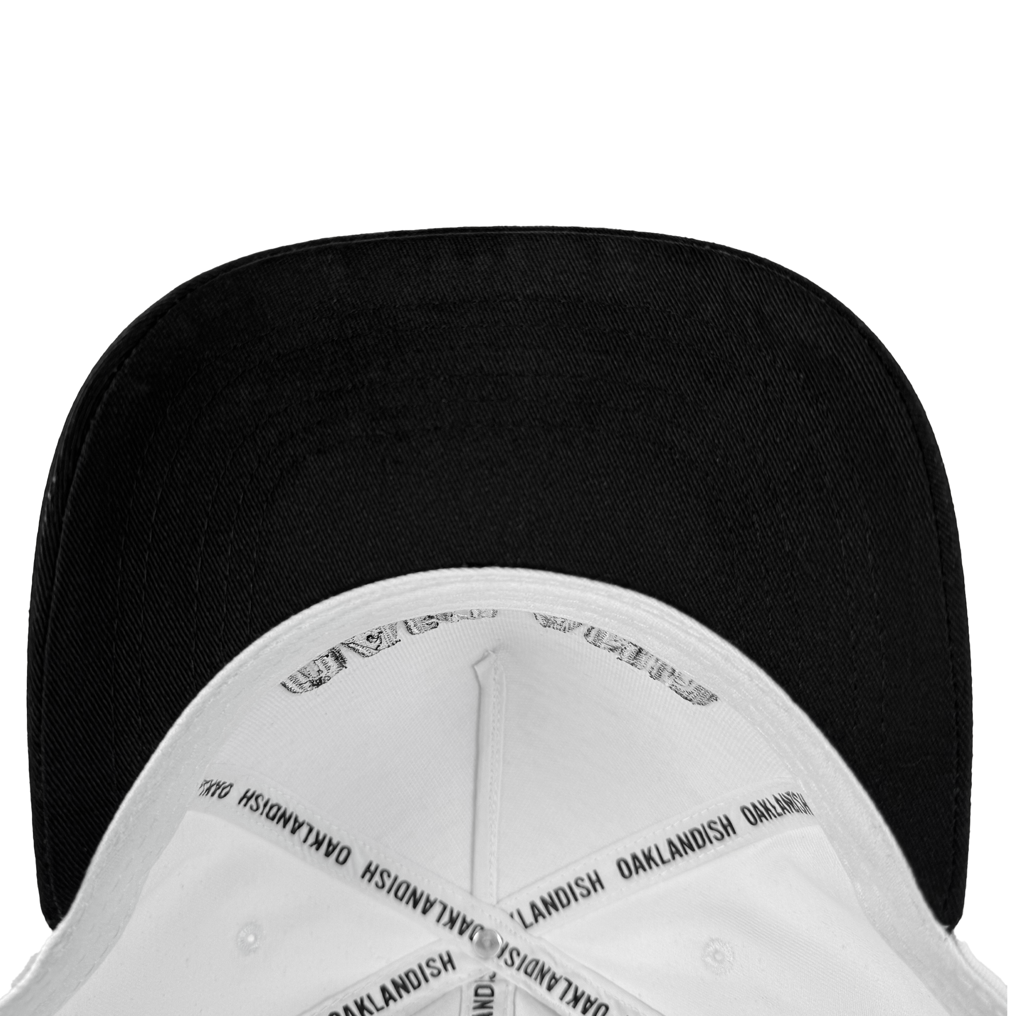 The Oakland Beisbol 5 Panel Cap by Oakland Ballers is a white snapback hat with a black underside of the brim. Inside seams have "OAKLANDISH" printed repeatedly on white tape. Shown from above on a plain white background.
