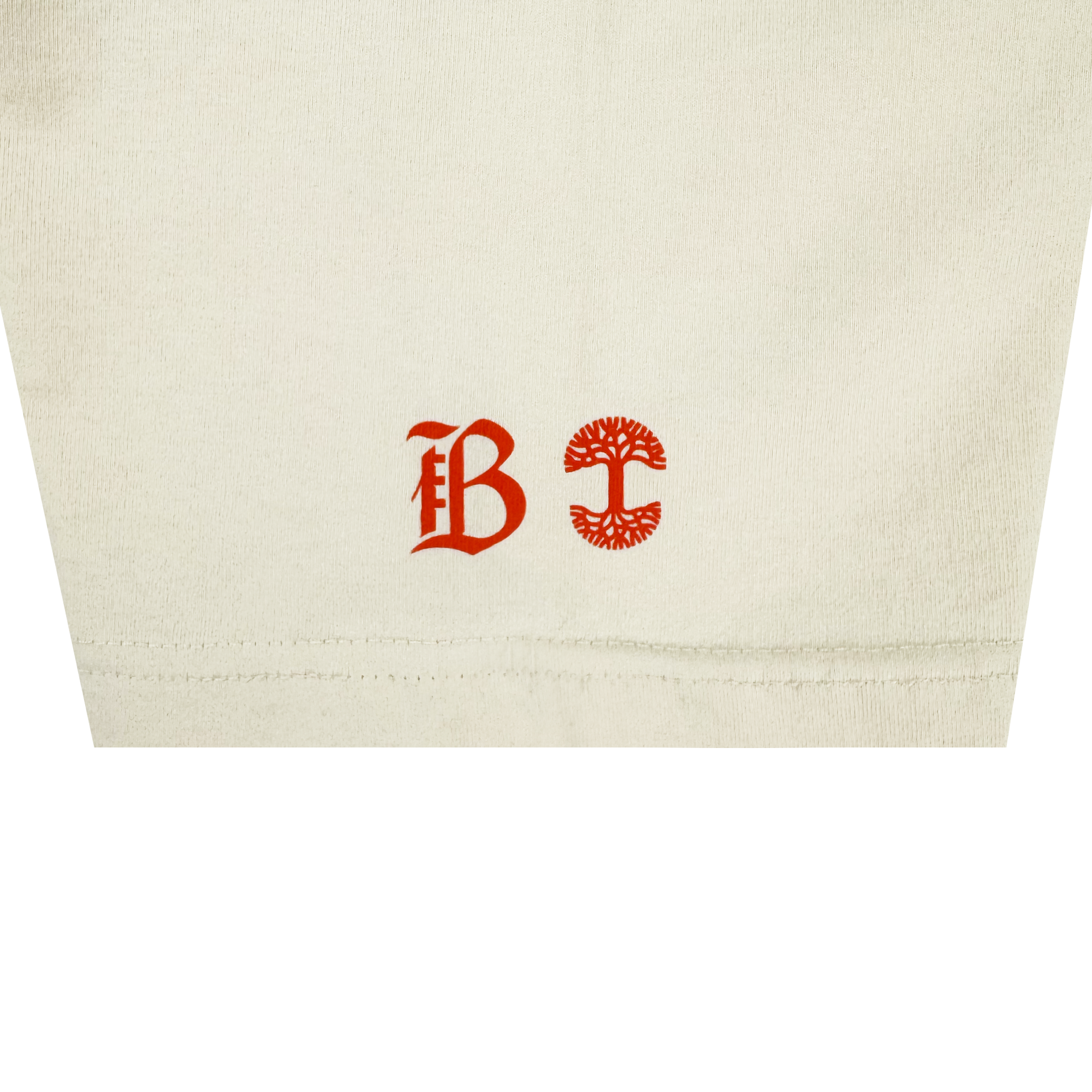 Close-up of heavy-weight cotton on the Bay FC Jubilee Tee: near the hem are two red symbols—a Gothic "B" on the left and a circular, tree-like emblem on the right.