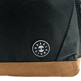 Close-up of Oaklandish tree logo and wordmark patch on a black backpack.