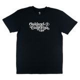Black t-shirt with white Oakland, California USA graphic in cursive and Oaklandish logo.