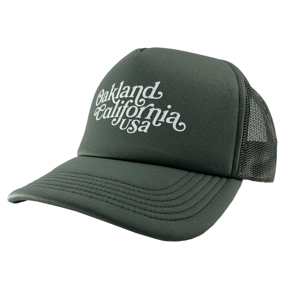 Front view of cypress green trucker cap with foam front panel, mesh back, adjustable with white Oakland, California, USA wordmark.