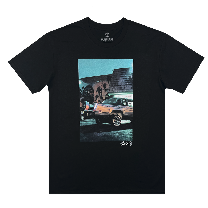 Image of Armando’s lowrider car parked in front of a Nipsey Hussle mural on the chest of a black Oaklandish t-shirt.