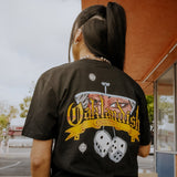 Backside view of women wearing a t-shirt with Oakland Crusin's graphic featuring a stylized rear view mirror and hanging dice.