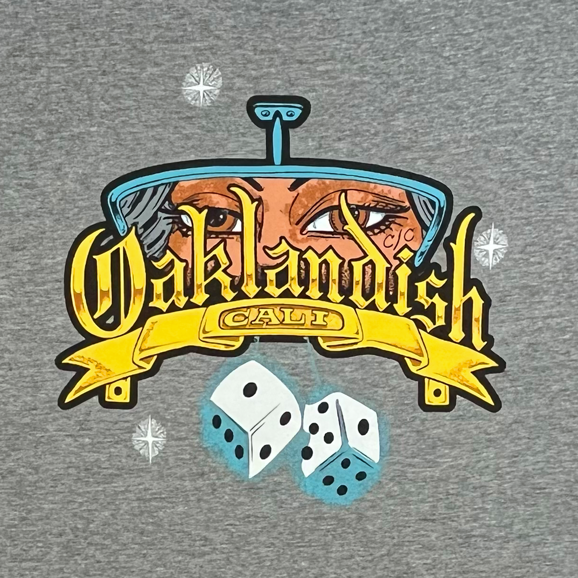  Close-up of Oakland Crusin' graphic featuring a stylized rear view mirror and hanging dice on a heather grey t-shirt.