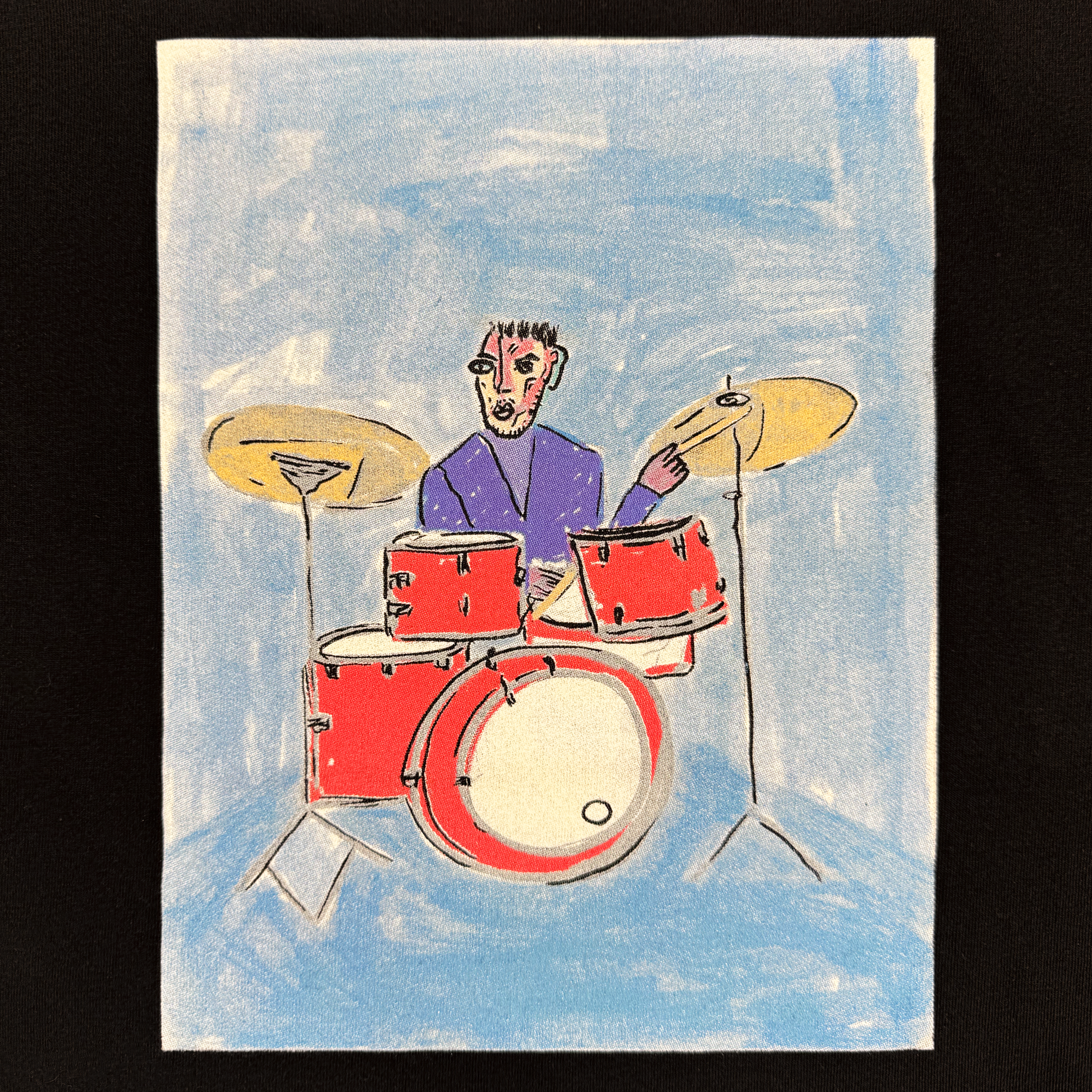 A vibrant illustration on the Drummin' Blues Tee by Oaklandish features a short-haired person in classic fit, playing a red drum set with two cymbals against energetic blue strokes that add dynamic energy to the scene.