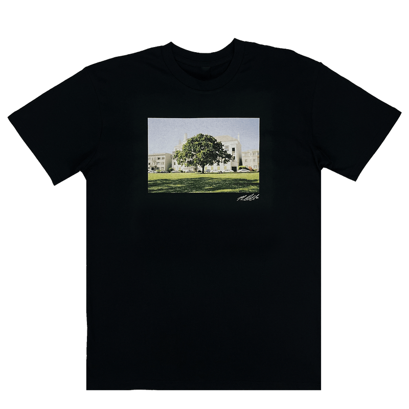 Black t-shirt with signed photographic image of a tree with a building behind..
