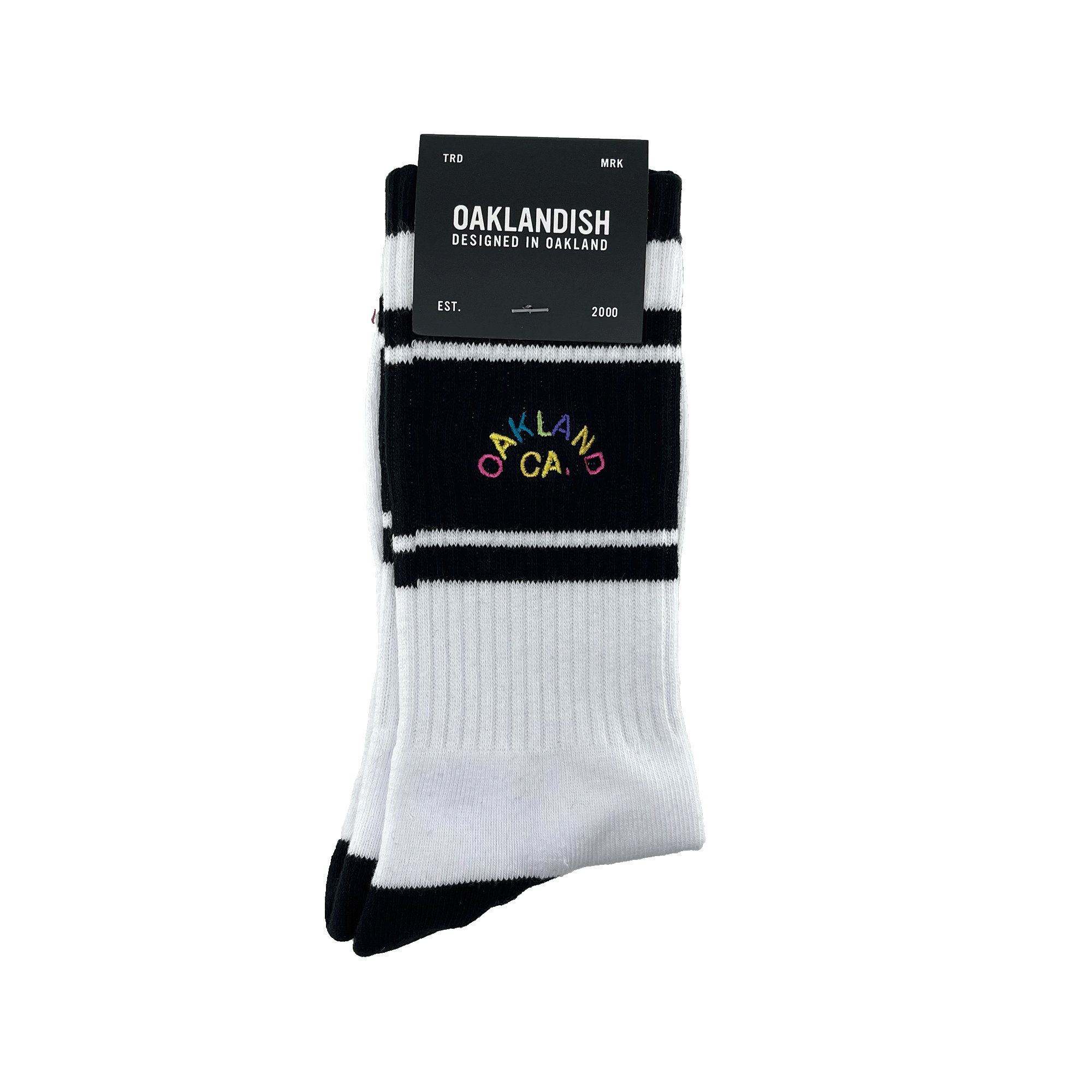 Pair of folded black and white crew socks in Oaklandish packaging with  full-color OAKLAND CALIFORNIA wordmark on the sock.