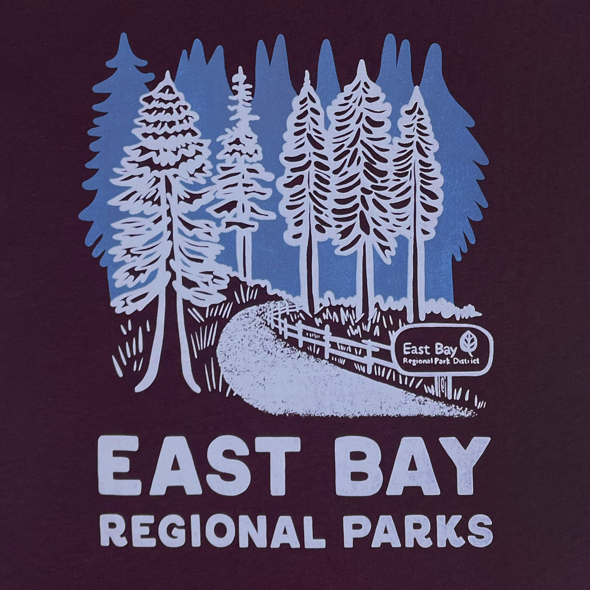 Detailed view of plum color cotton t-shirt with East Bay Regional Parks artwork.