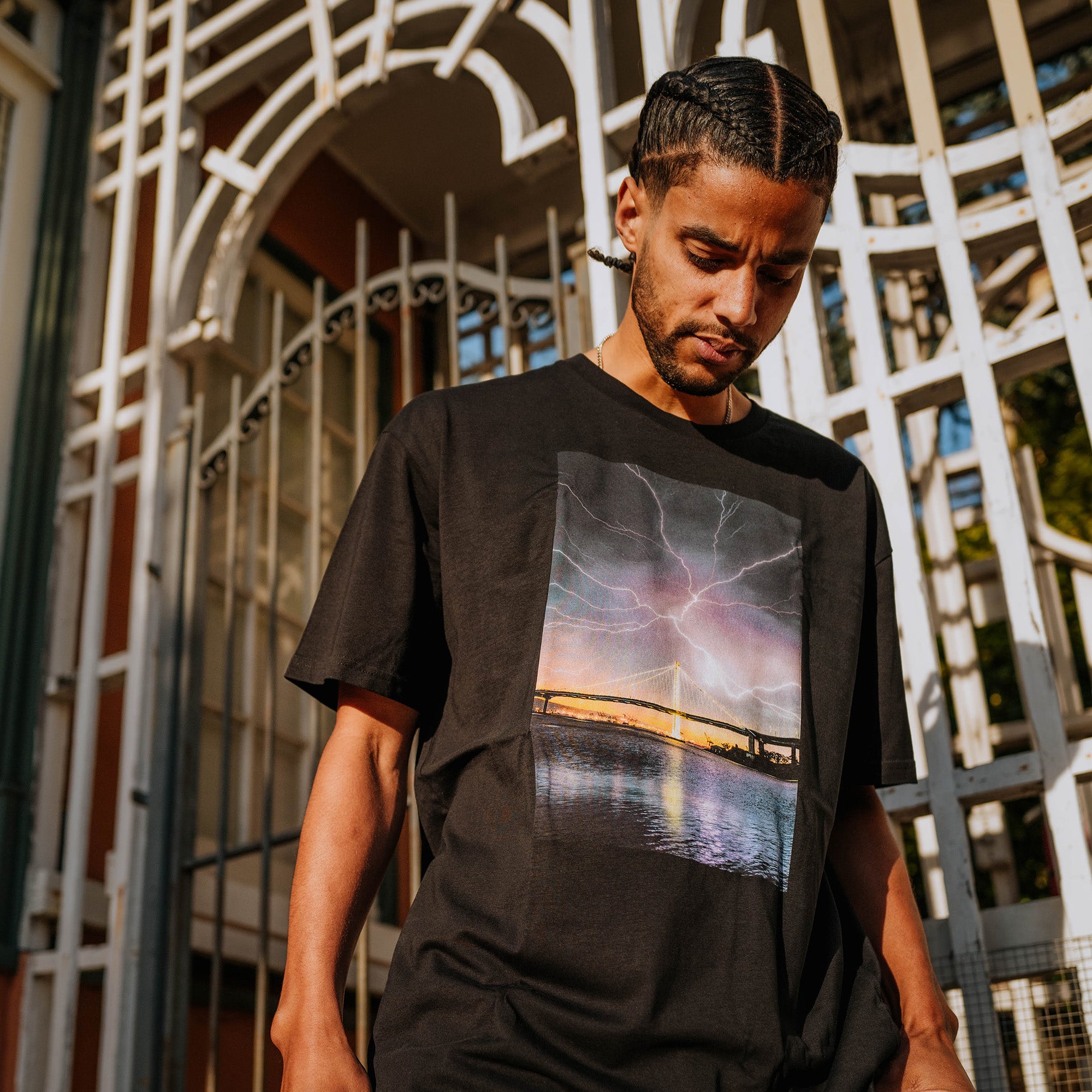 Male model wearing black t-shirt with image of lightening in Oakland by photographer Vincent James.