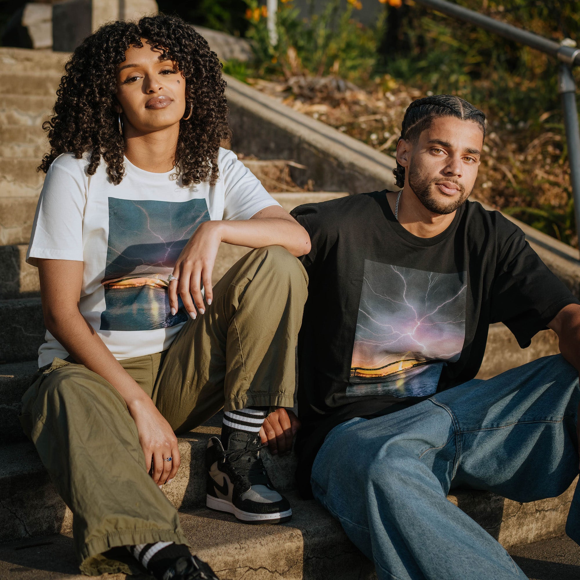 Female and Male model wearing t-shirts with image of lightening in Oakland by photographer Vincent James.