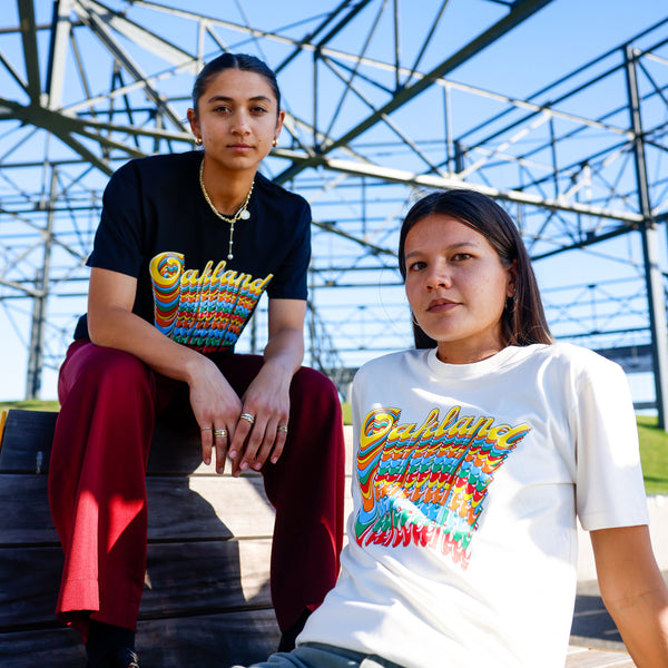 Models wearing Oakland Roots RC Funk tees in black and natural outside.